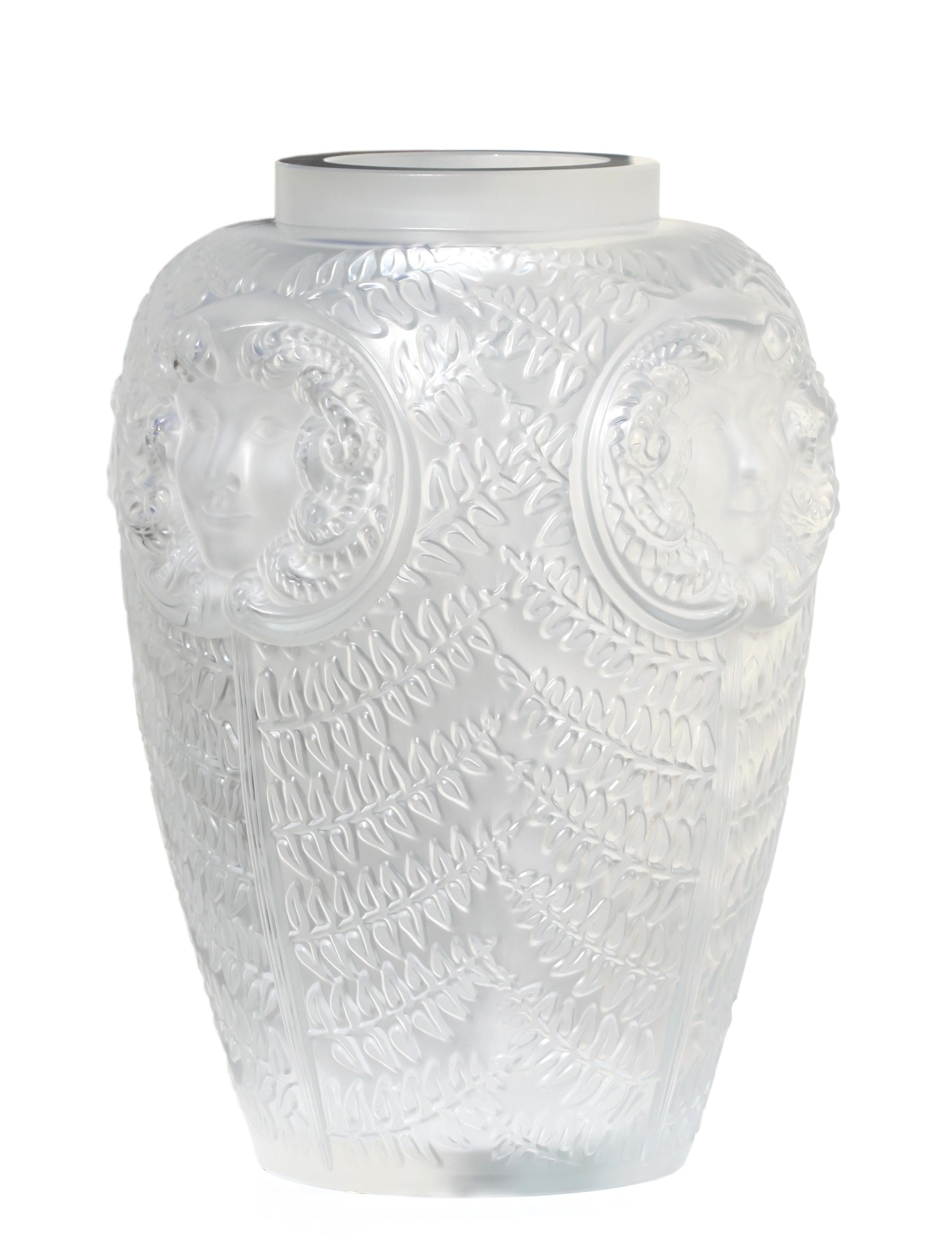 A large and impressive Lalique Masque De Femme pattern covered vase, France, 20th century, 
engraved 'Lalique France' to cover and numbered 99
Measures: approximately 88cm., 21 1/2 in. high
33cm., 13 in. width
Provenance:
Property of A Palm