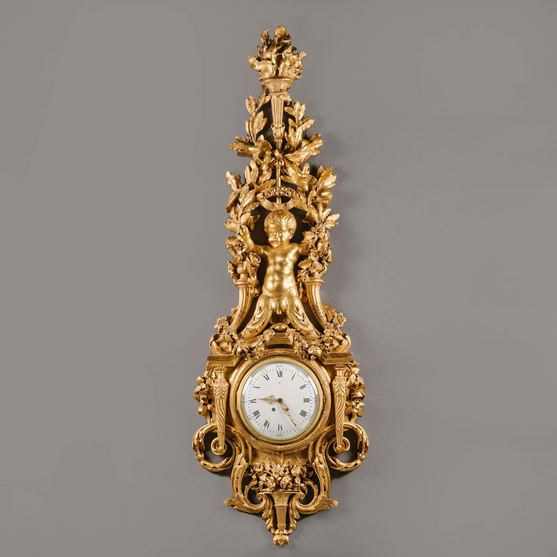 A large and important Louis XVI style carved giltwood clock and barometer set.

Each with circular enamel dials, the clock with Roman and Arabic numerals and pierced scrolled hands. The companion barometer with indications for the weather and