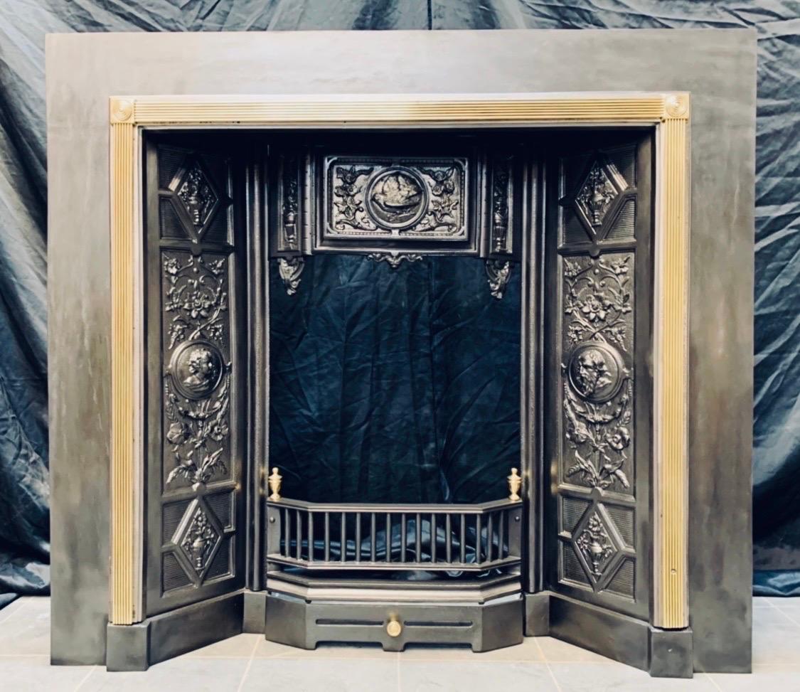 A large and highly ornate, Scottish, probably Carron of Falkirk -cast iron and brass fireplace insert.
A large outer plate with an attached polished steel raised border surmounted with polished brass reeding on all three sides , a pair of polished