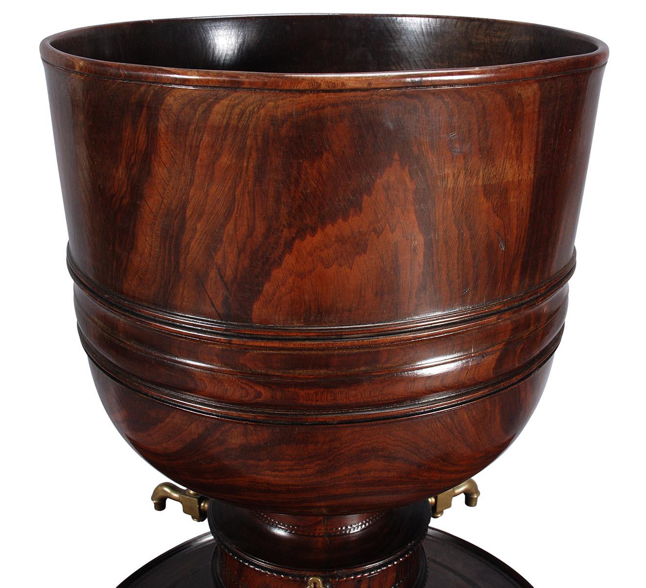 An exceptionally large example of a traditional wassail vessel turned out of lignum vitae. Due to the immense size, it has been turned in three parts. The bowl, stem, and plinth are turned separately with wooden threads so that they screw together.