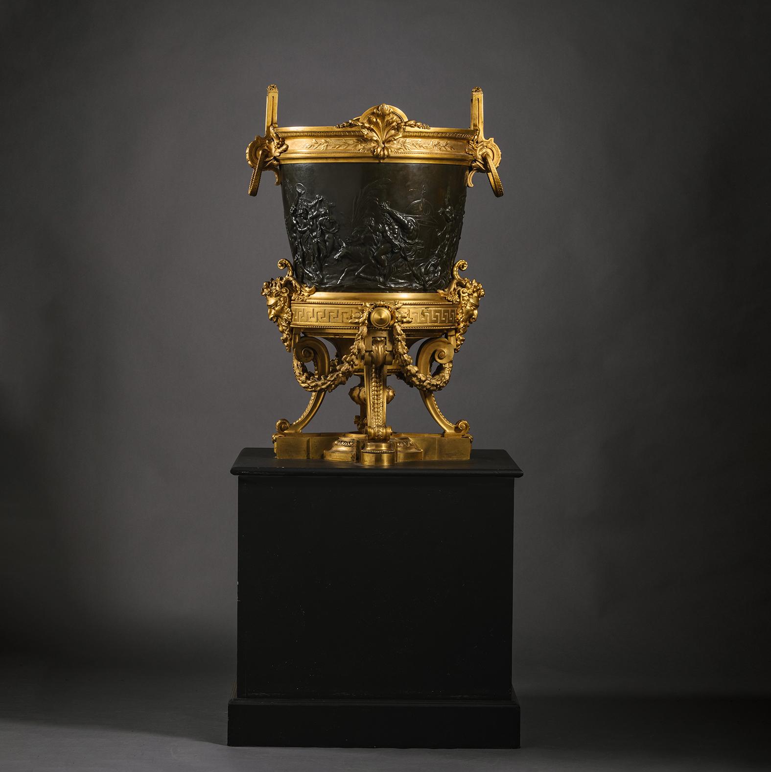 A Large and Rare Gilt and Patinated Bronze Jardiniere or Monumental Wine Cooler. 

With upright scroll handles over a cylindrical body cast with scenes of a bacchic procession and centred by Bacchus and Ariadne on a cheetah-drawn chariot, above a