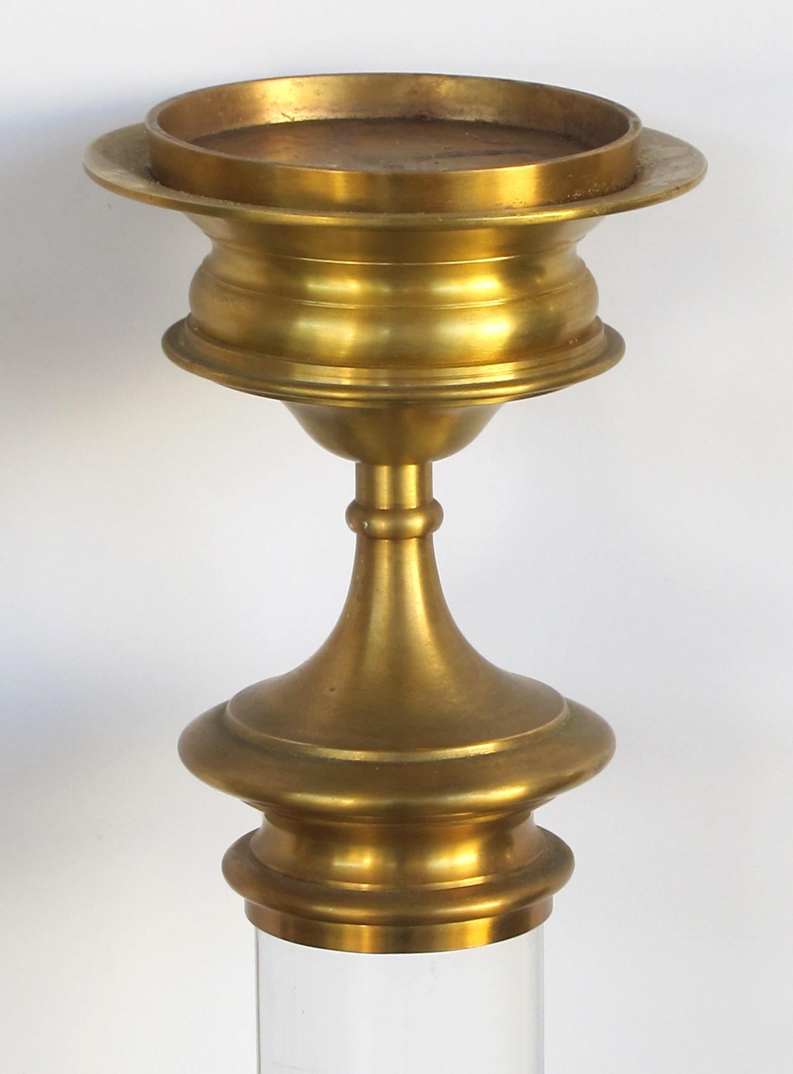 A large and striking pair of American 1960s brass and Lucite candlesticks.