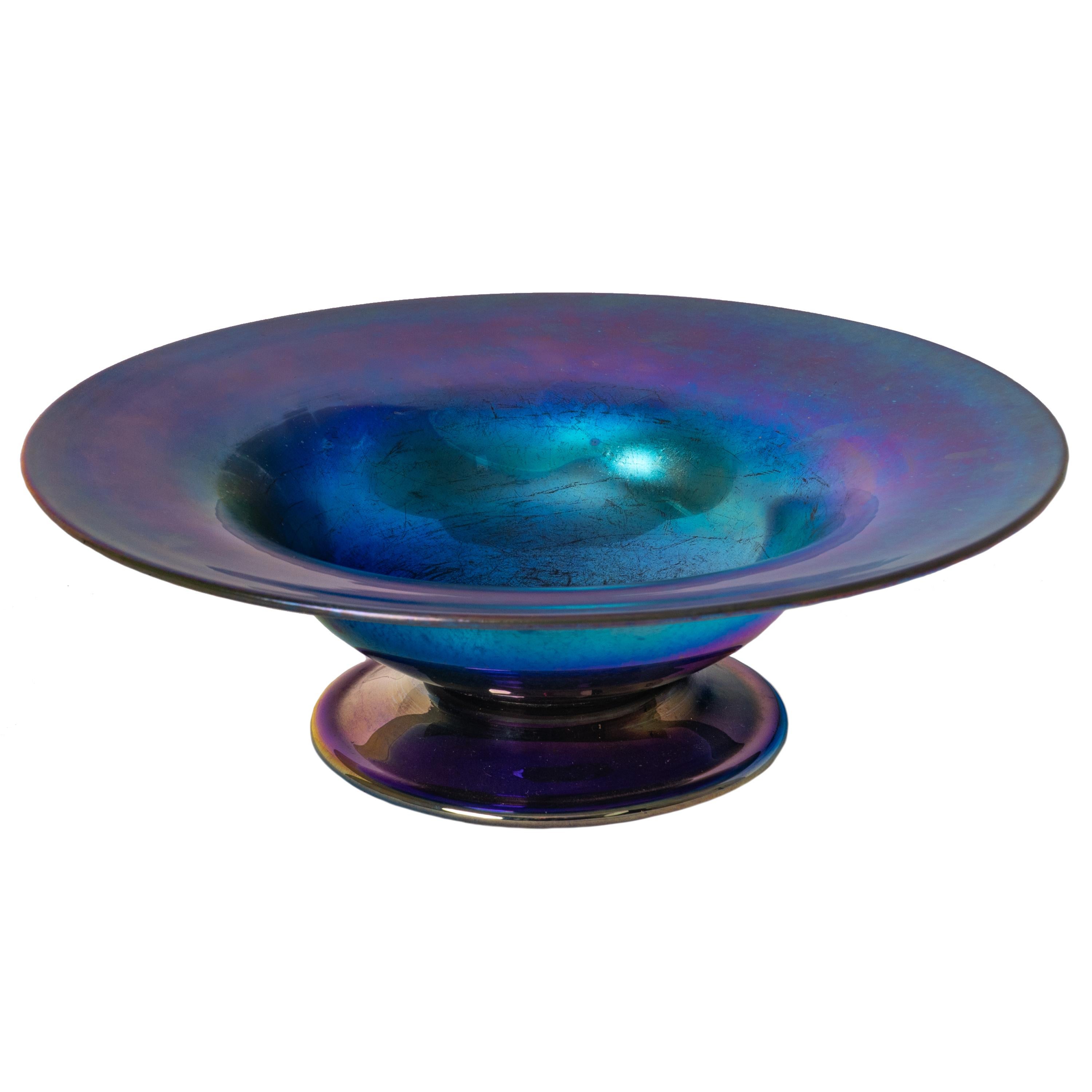 A good antique Art Nouveau L. C. Tiffany blue Favrile footed glass bowl/compote, circa 1910.
Tiffany Favrile compotes are not uncommon in gold and much rarer in blue, especially this intense blue with purple highlights. This beautiful iridescent