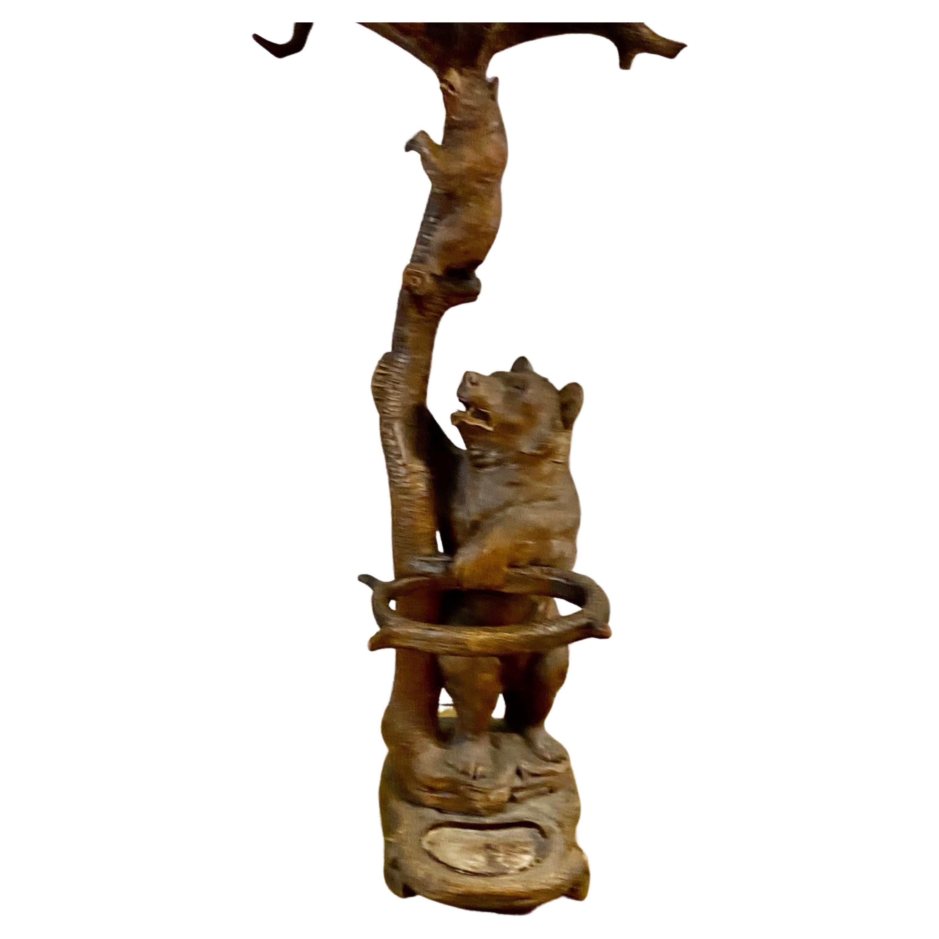 This exquisite coat stand is a true masterpiece of antique woodenware. 
Crafted from high-quality wood, this coat stand features three beautifully carved bear figures, showcasing the intricate style of the Black Forest period.
With its impressive