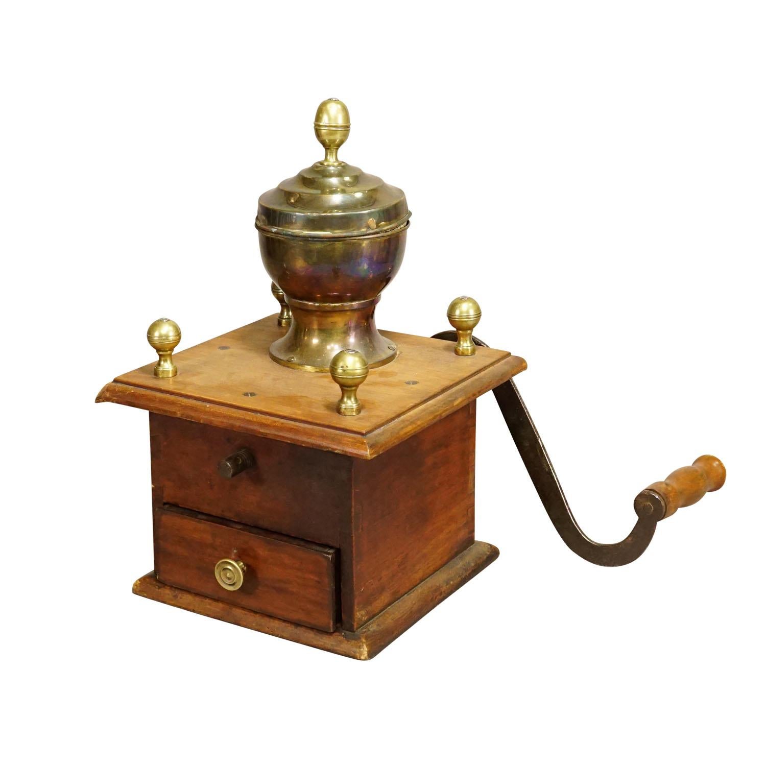 A Large Antique Coffee Grinder, Germany circa 1900s

A large antique coffee grinder manufactured in Germany around 1900. Made with nutwood, iron crank and brass container for coffee beans. Very good condition, working order.

Measures:
Width: 10.63