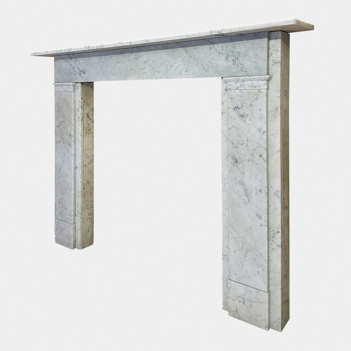 A Large English William IV period Carrara marble fireplace surround. The wide pilaster jambs with slim panel to centre. The long running frieze from side to side under a large simple mantel. A nice example of this period of surround, from the
