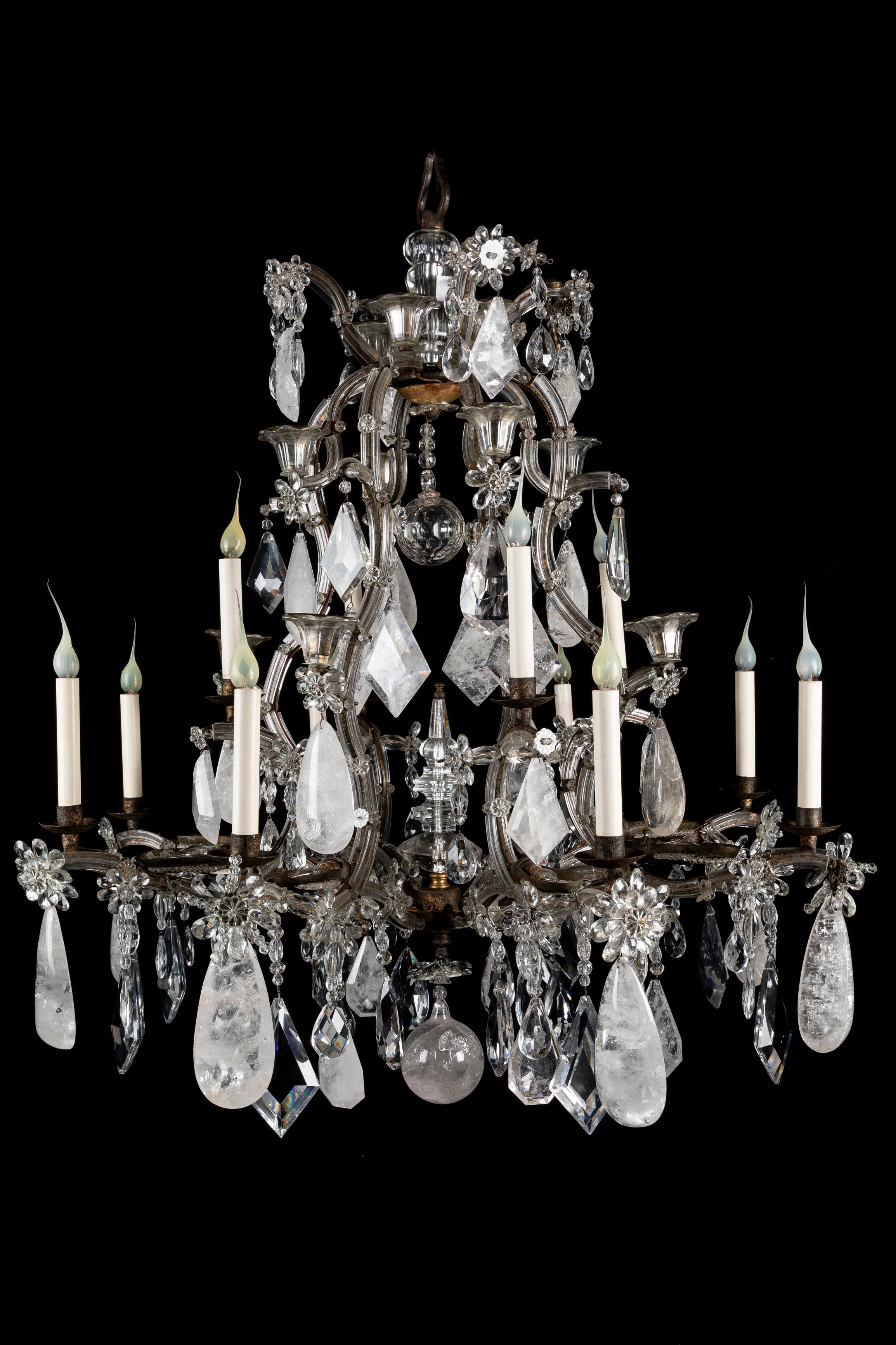 A Spectacular and Large French Bagues Style rock crystal, glass and patinated iron multi light double tier chandelier of super craftsmanship. This unusual chandelier is embellished with large cut rock crystal prisms, crystal flowers, glass mounted
