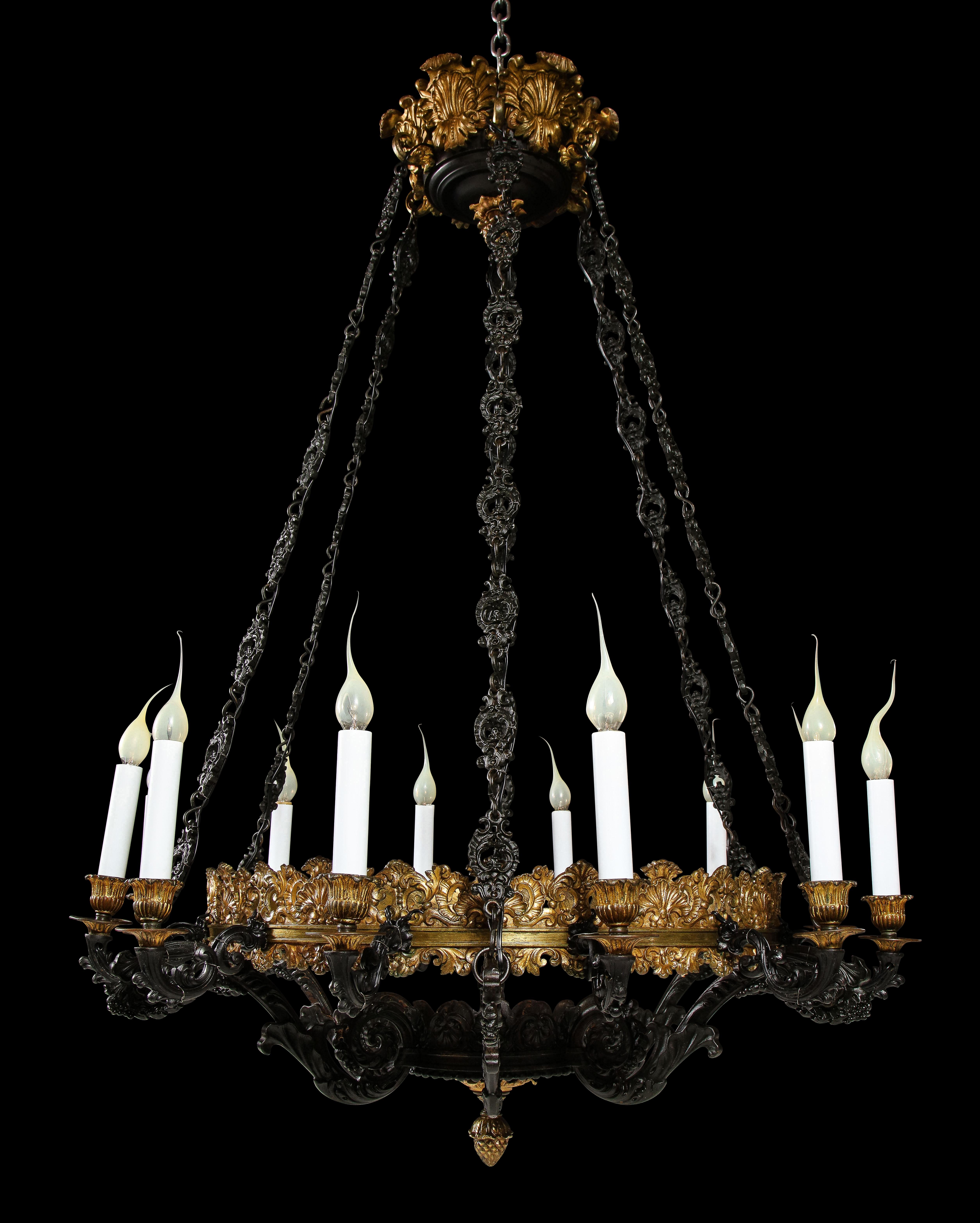 A Large and very impressive Antique French Empire style gilt bronze and patinated bronze circular form multi light chandelier of fine detail . This large unique chandelier consists of twelve patinated bronze arms embellished on a circular gilt