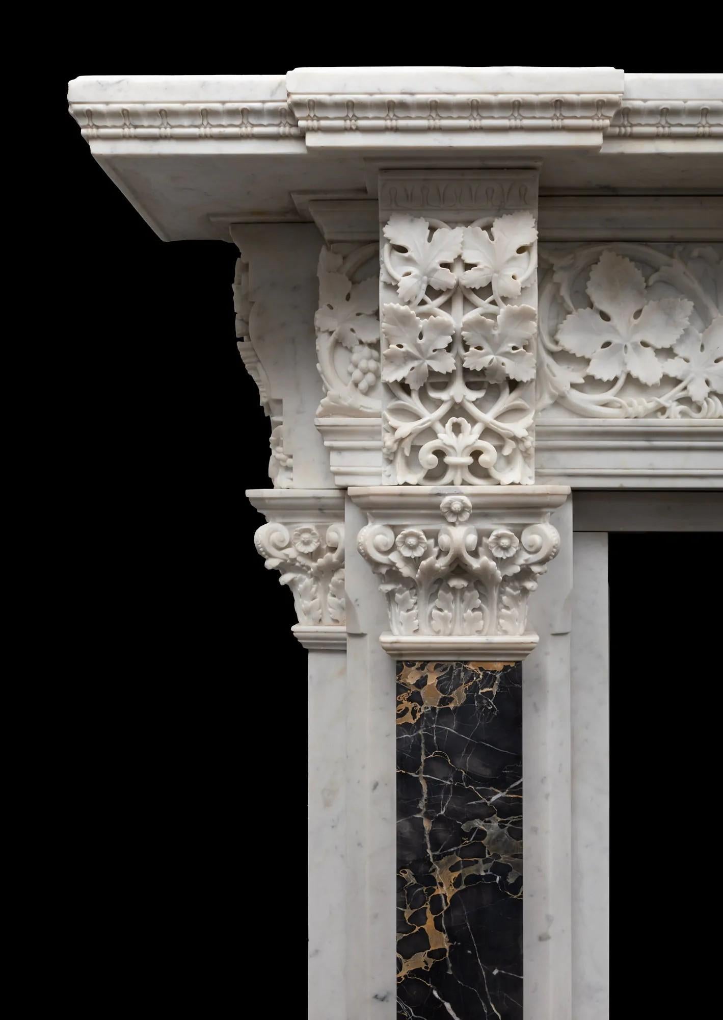 A large and incredibly well carved antique Italian Carrara marble fireplace in the Renaissance style
Made in Venice during the middle of the 19th century in the Renaissance revival style.

The coloured Portoro marble pilasters are under intricately