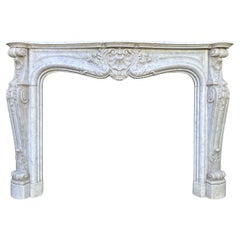 A large Antique Louis XV French Rococo Carved Marble Fireplace Mantel
