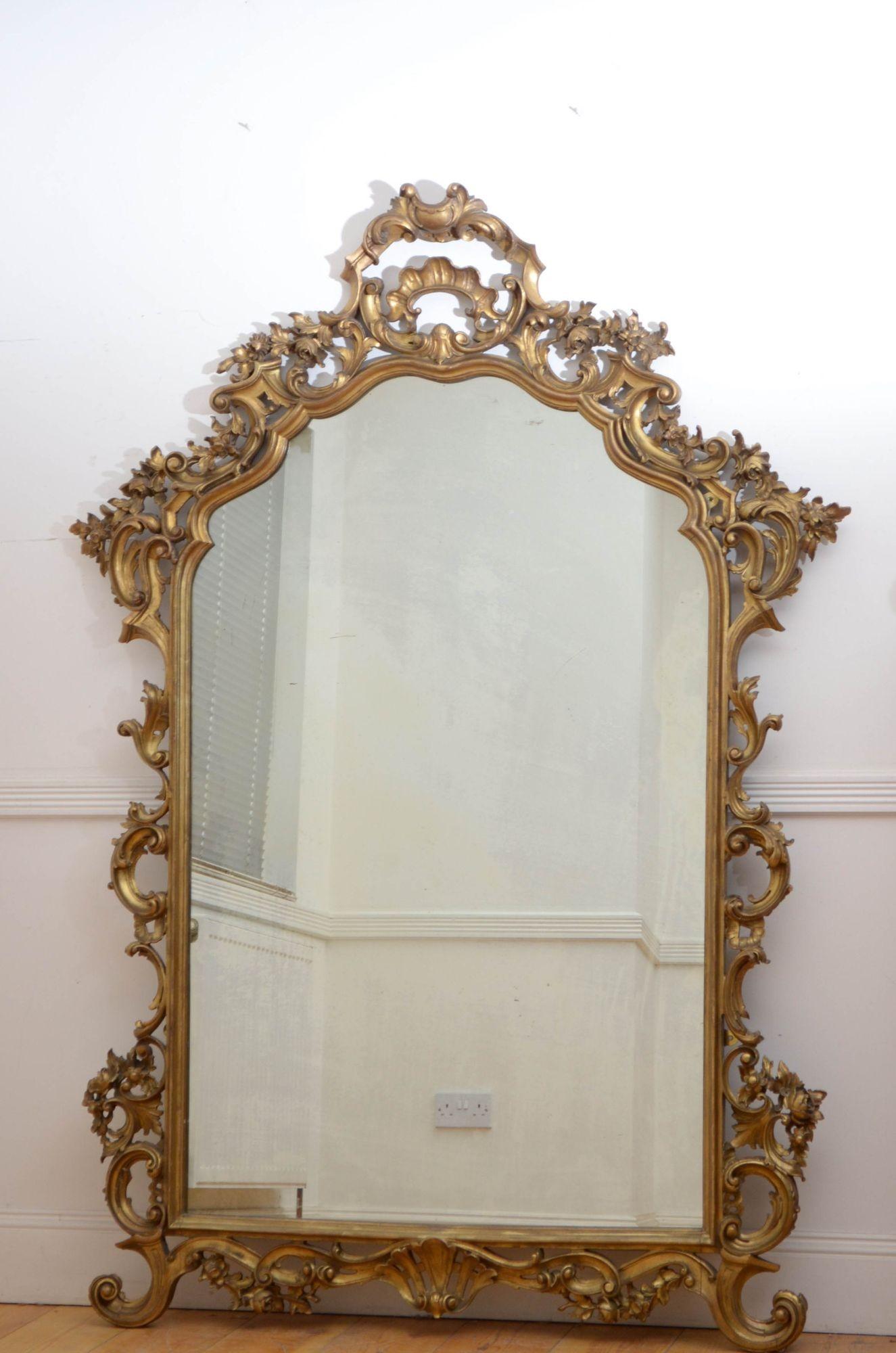 Sn5440 Superb large 19th century Italian leaner mirror or wall mirror, having original glass with some foxing and minor imperfections in wood carved frame, decorated with scrolls, leaves , shells and flowers. This antique gilt mirror is in home