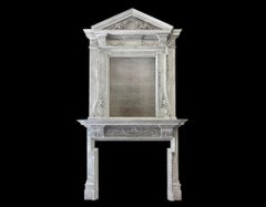 A large antique painted wooden fireplace with overmantel mirror