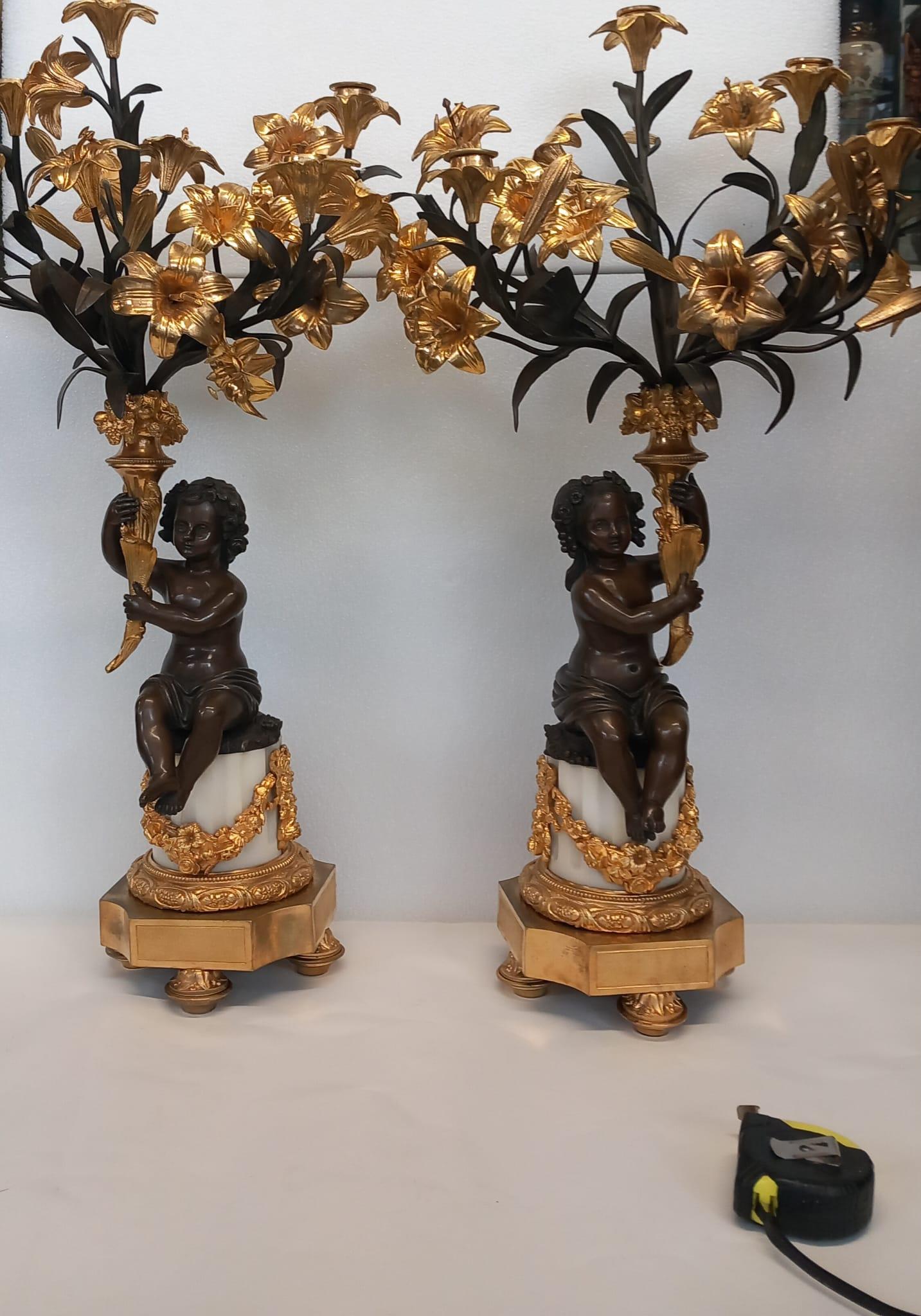 Gilt A large antique pair of French neoclassical candelabra in dark and gilt bronze  For Sale