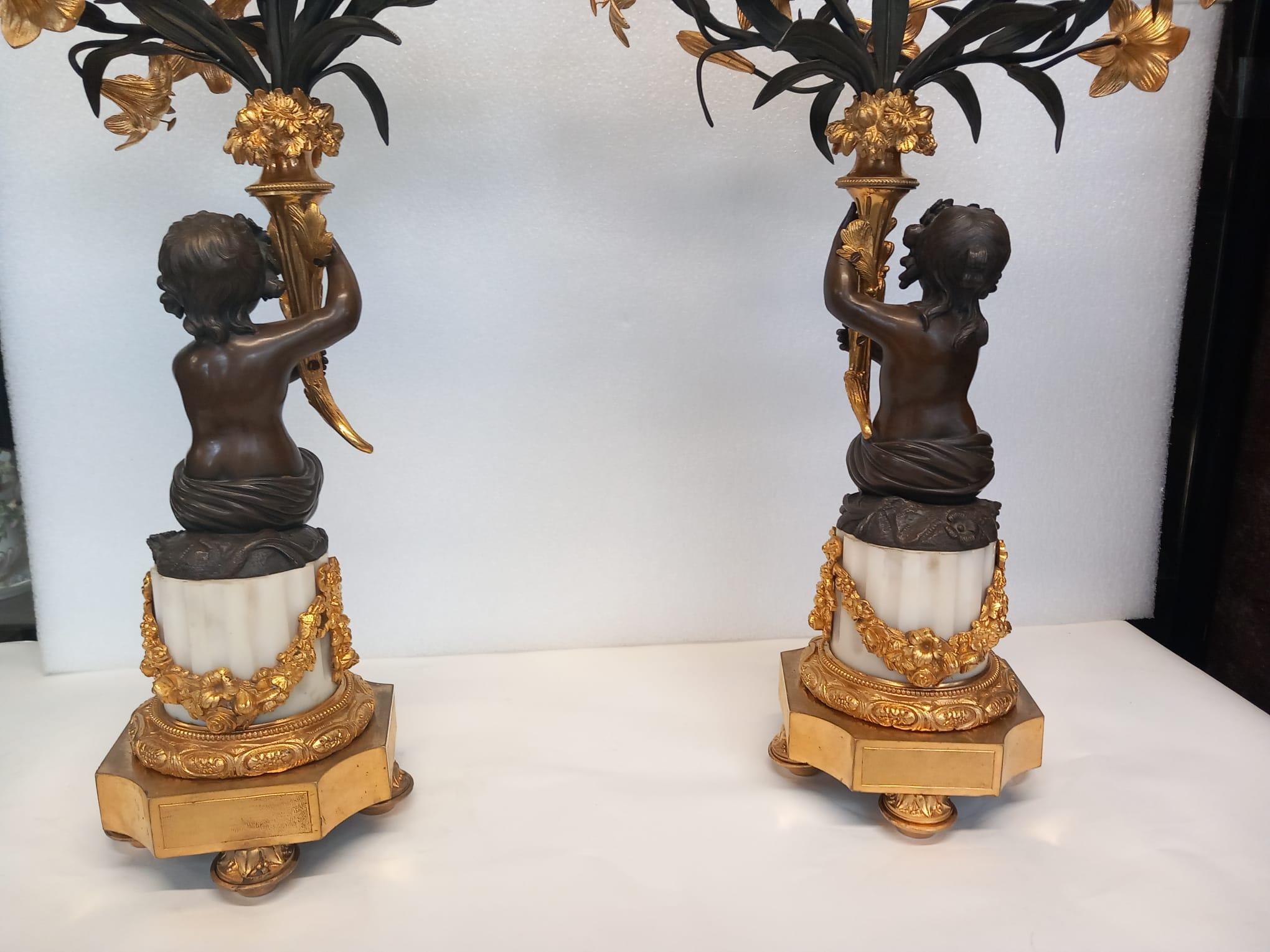 Bronze A large antique pair of French neoclassical candelabra in dark and gilt bronze  For Sale