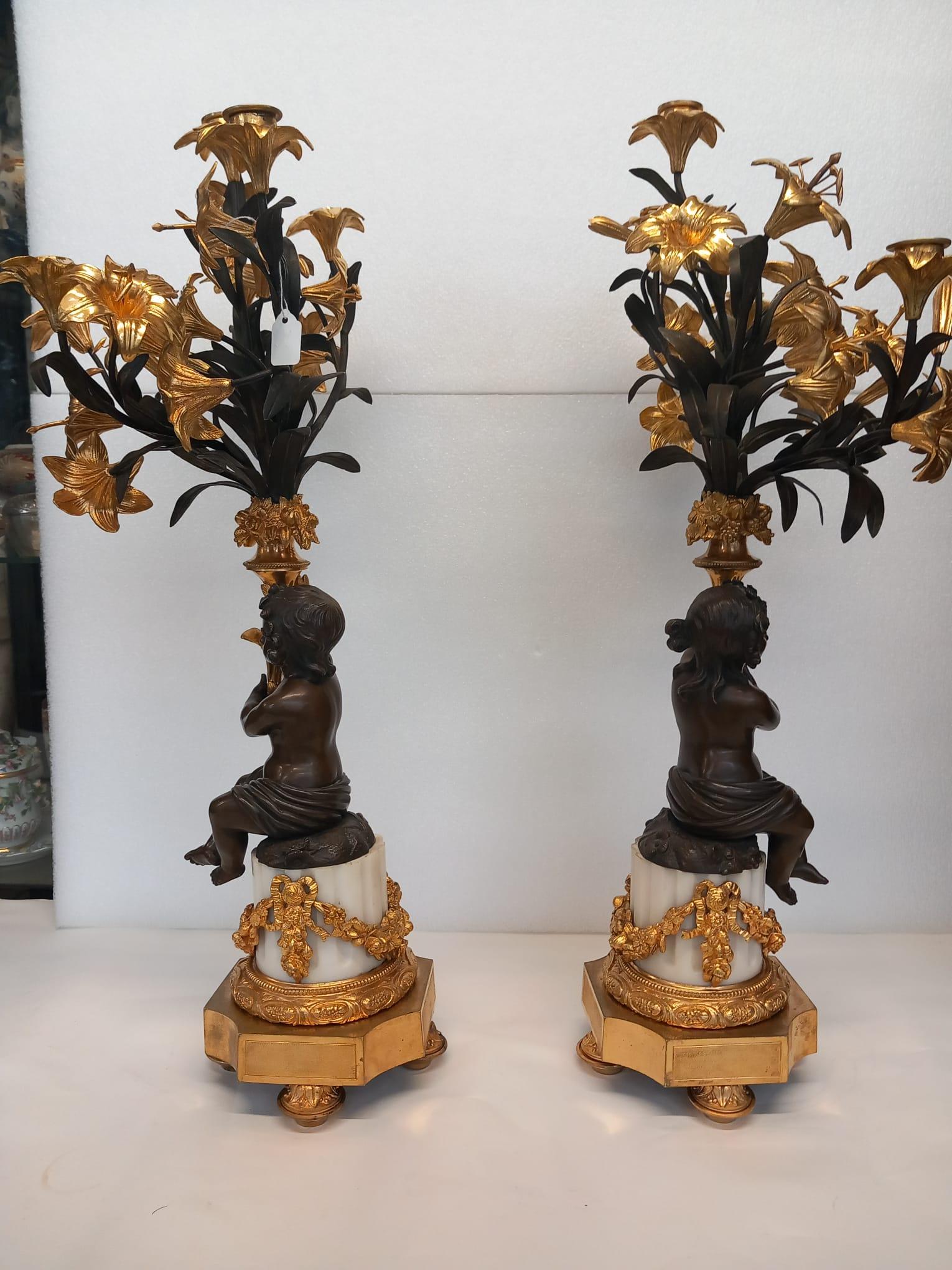 A large antique pair of French neoclassical candelabra in dark and gilt bronze  For Sale 1