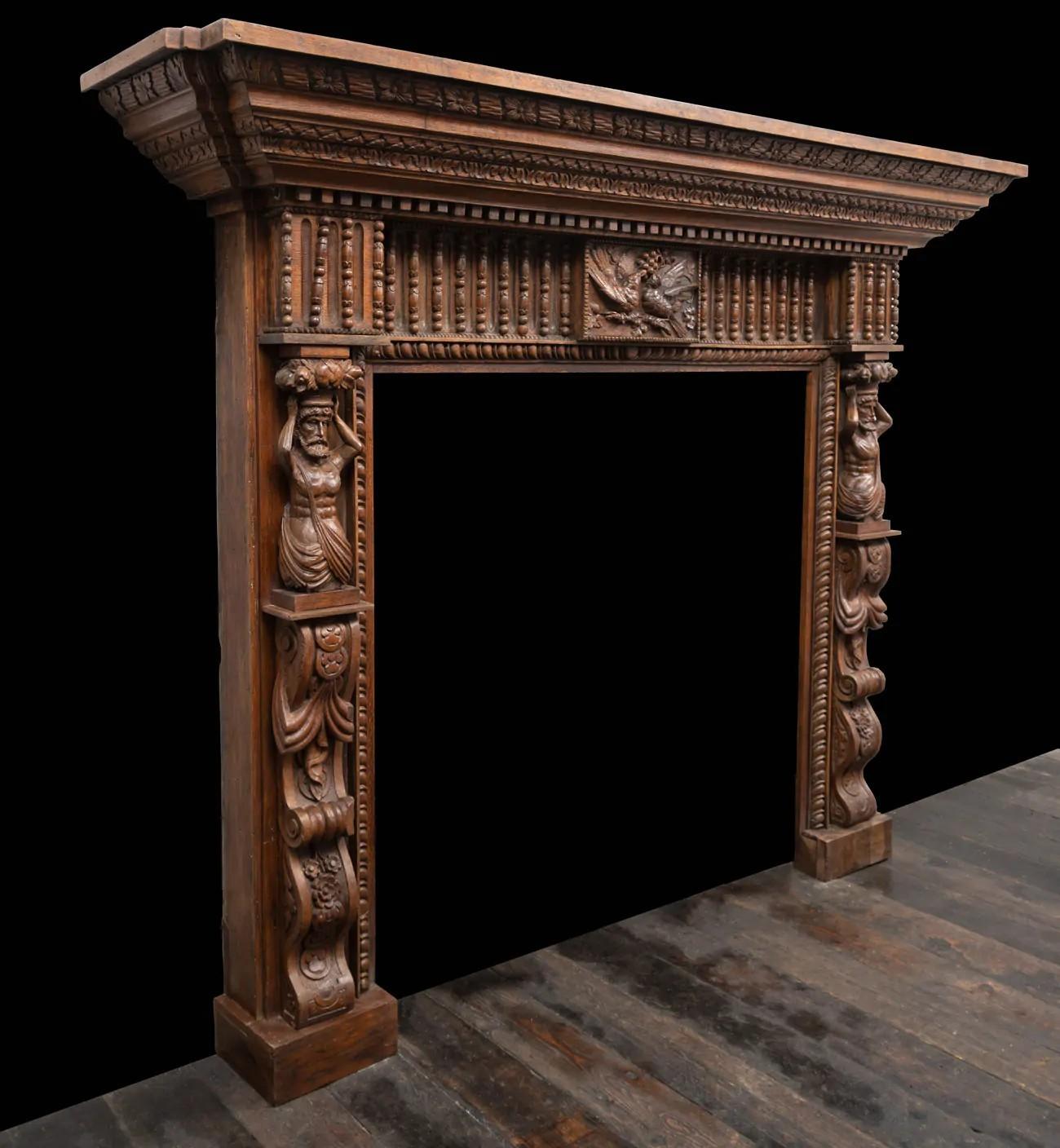 English A large antique profusely carved oak fireplace surround in the Jacobean style For Sale