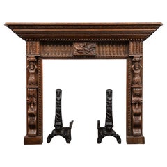 A large antique profusely carved oak fireplace surround in the Jacobean style