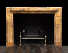 A large antique Sienna marble bolection frame style mantel or fireplace surround