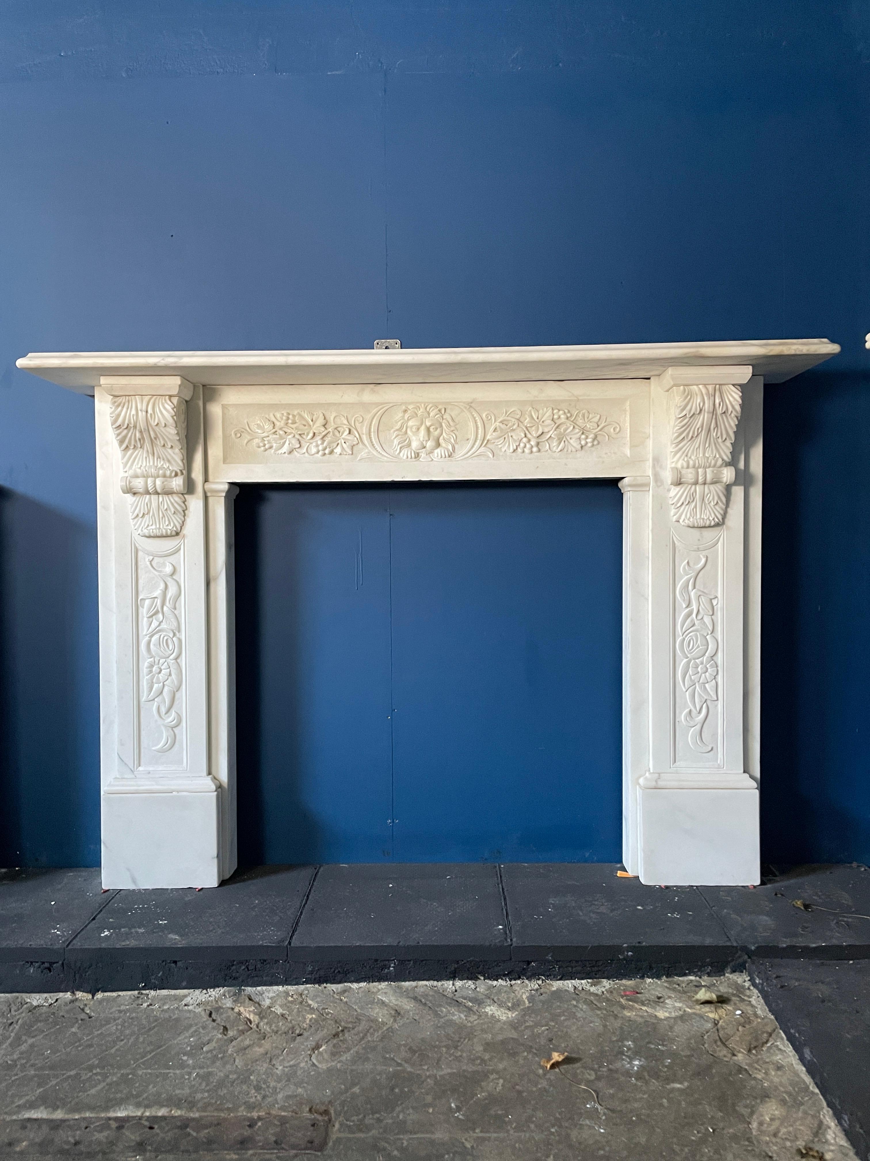 A large statuary white marble victorian period fireplace. The jambs with carved panels to the front of foliage and flowers. The carved feathered corbel brackets supporting a large and generous shelf above. Beneath a carved frieze again of foliate