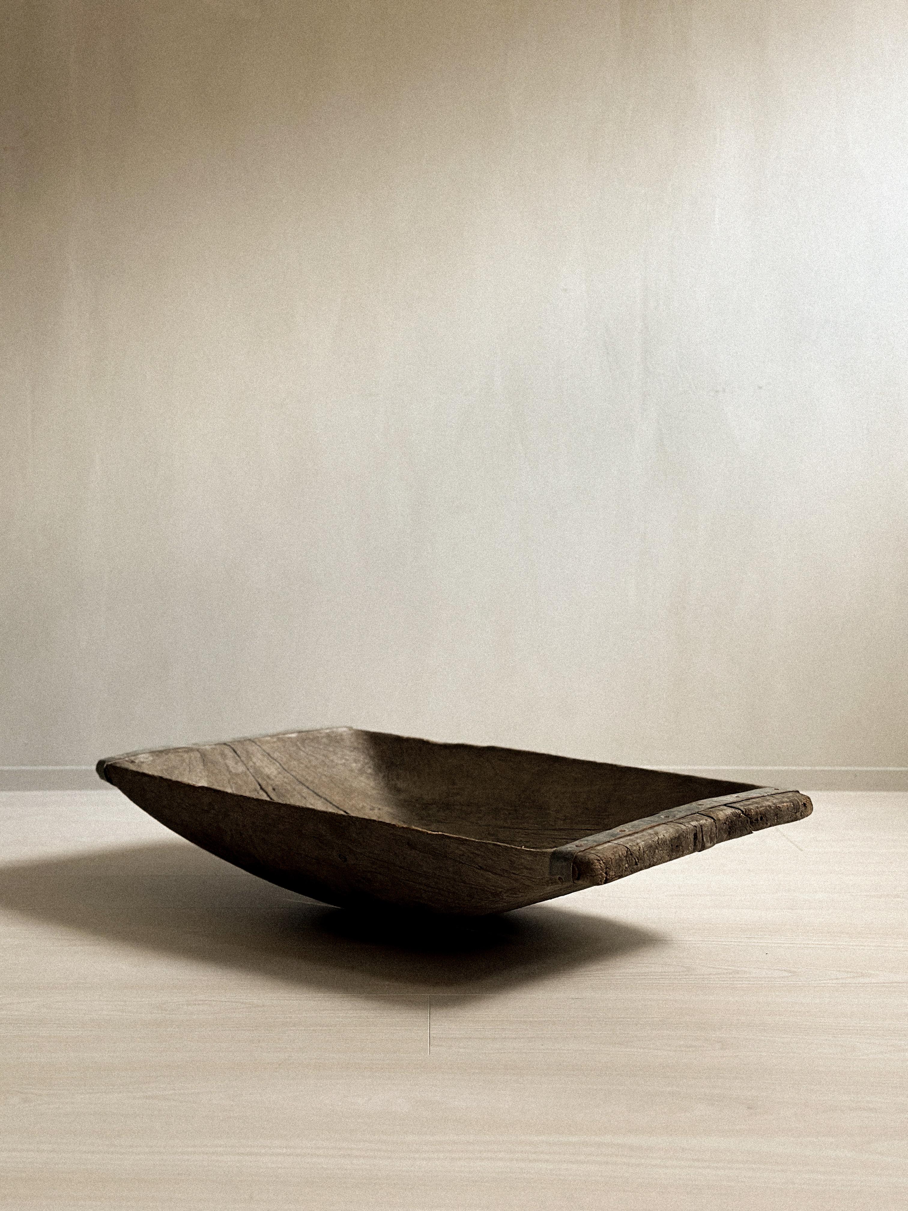 A large antique wabi sabi tray with heavy patina from age and use. Old repiars with metal. 