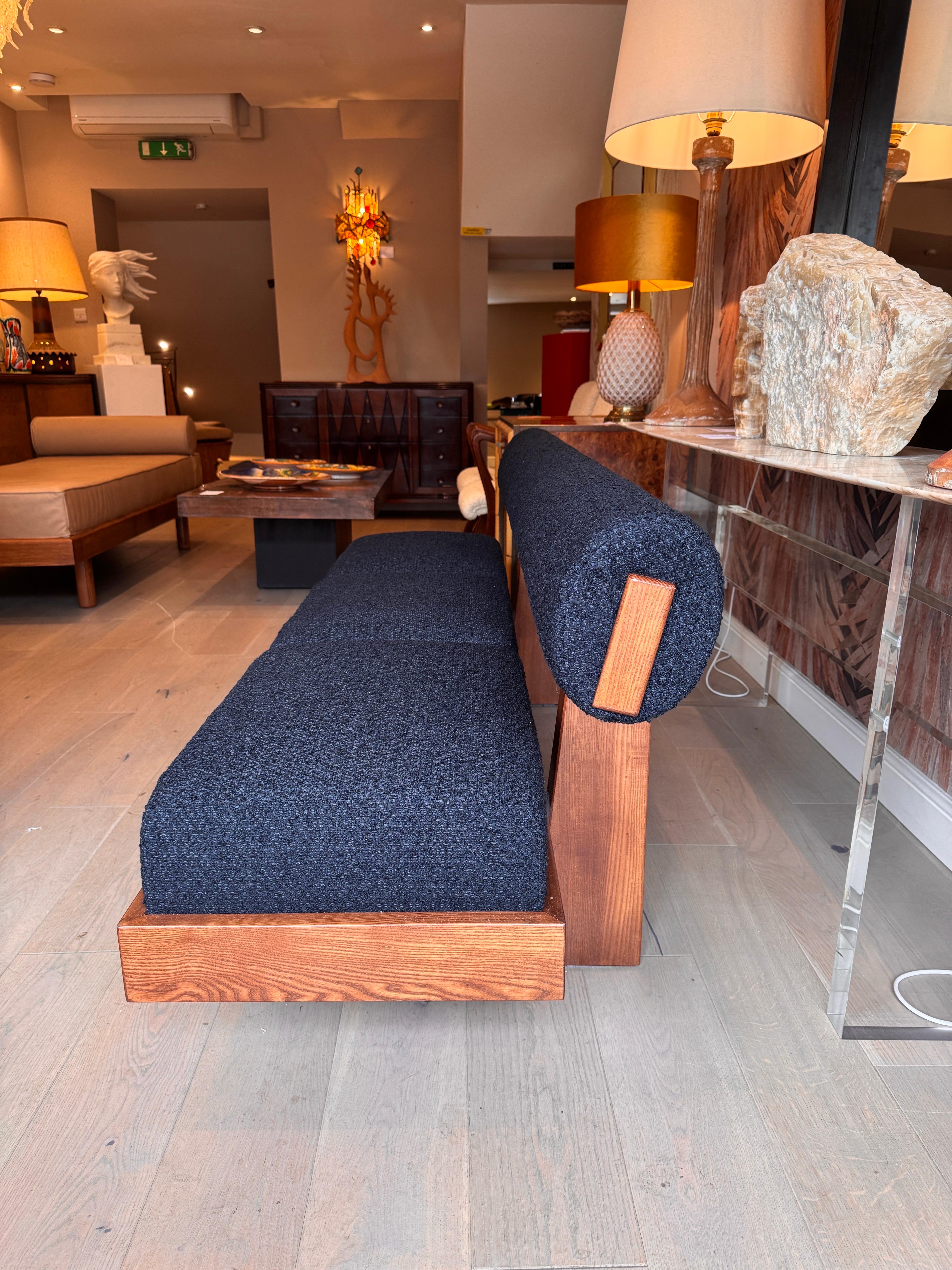 Modern A large architectural bench with a back rest in navy blue boucle . For Sale