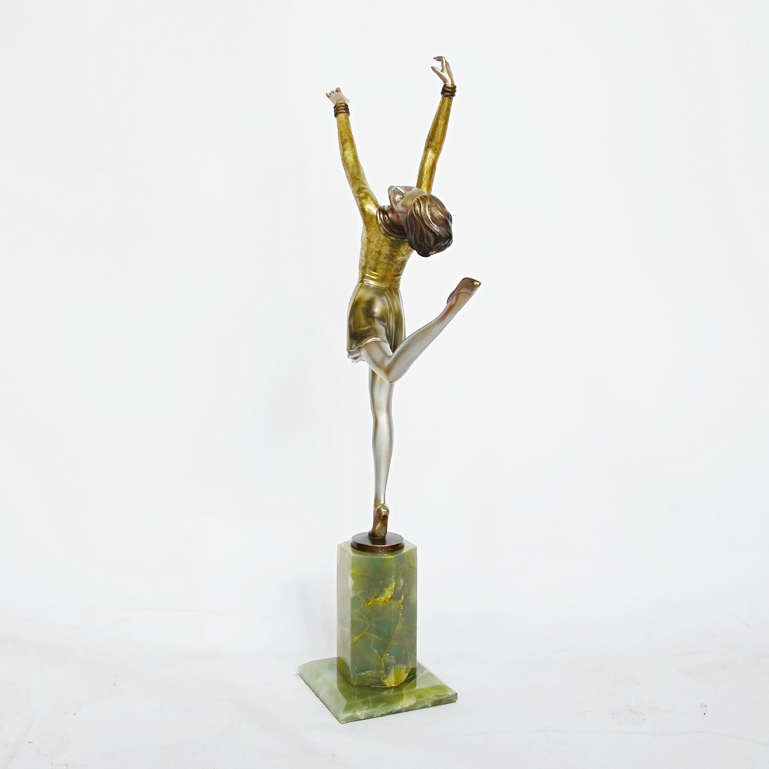 A large Art Deco, cold painted silvered bronze figure by Josef Lorenzl (1892-1950). A dancing woman in stylized pose set over a green onyx plinth. Original color and patination. Signed Lorenzl to bronze

Excellent original