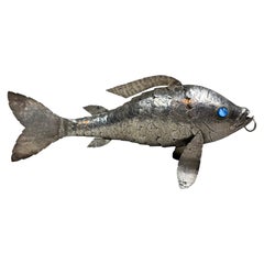 A large articulated silver fish with glass eyes