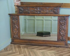 A Large Arts and Crafts Carved Oak Overmantel or Wall Mirror