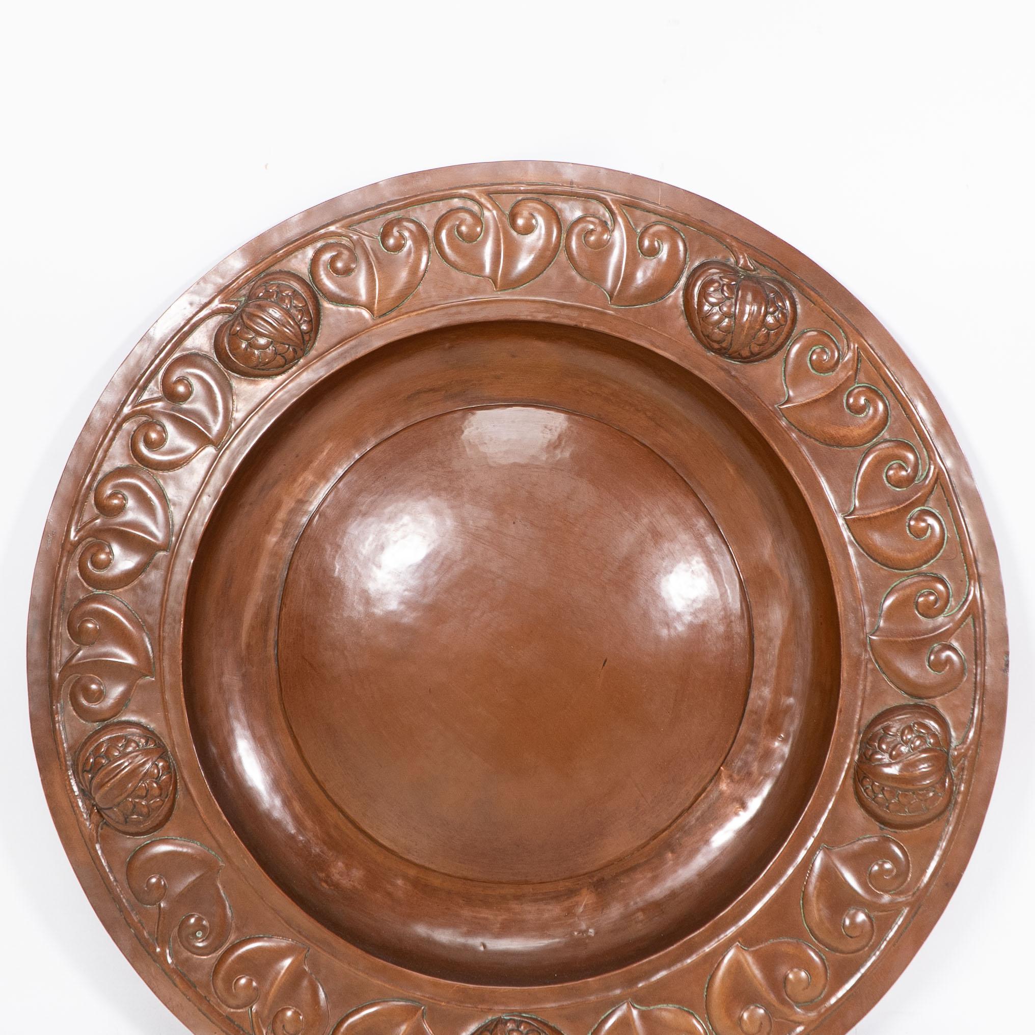 Copper A large Arts and Crafts hand formed copper charger with stylized decoration For Sale