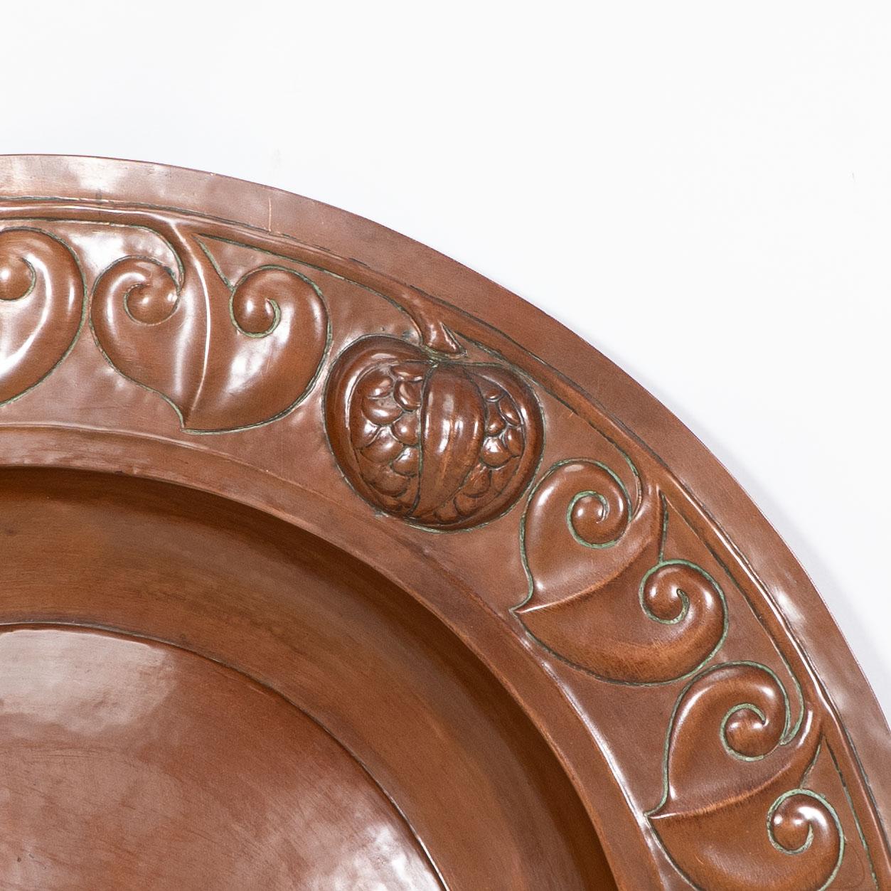 A large Arts and Crafts hand formed copper charger with stylized decoration For Sale 3