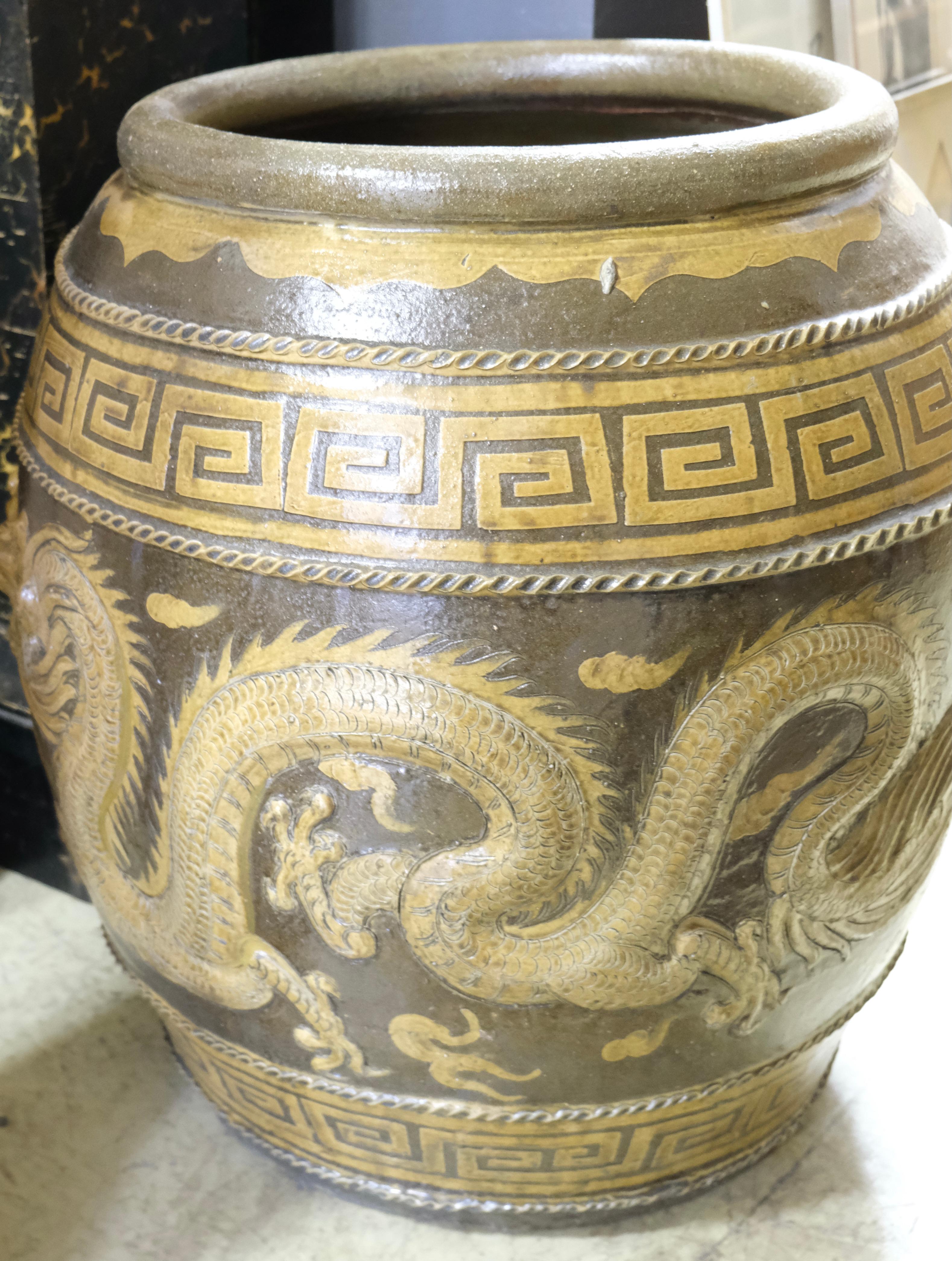 This is a wonderfully designed urn with motives of two dragons. The dragons has inlaid glass eyes and all relief is deep and gives a three dimensional look. The colors goes in beige and brown. It can be used just as a decoirative object or as a urn