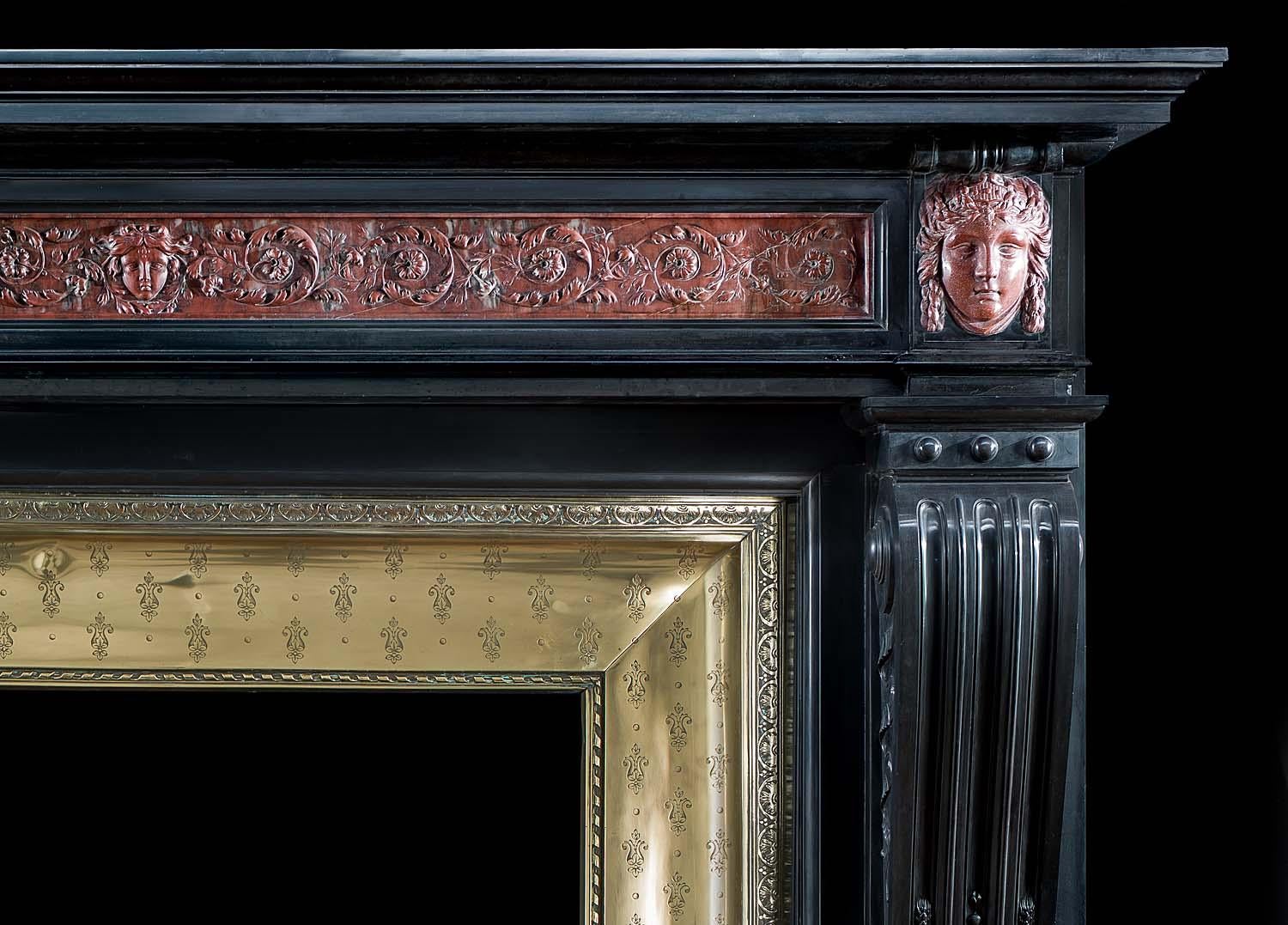 Grande et imposante cheminée Louis XVI en marbre noir belge, avec la frise et les embouts sculptés en marbre rouge du Languedoc, ainsi que son insert en laiton d'origine. L'étagère moulée en gradins repose au-dessus d'une large frise richement