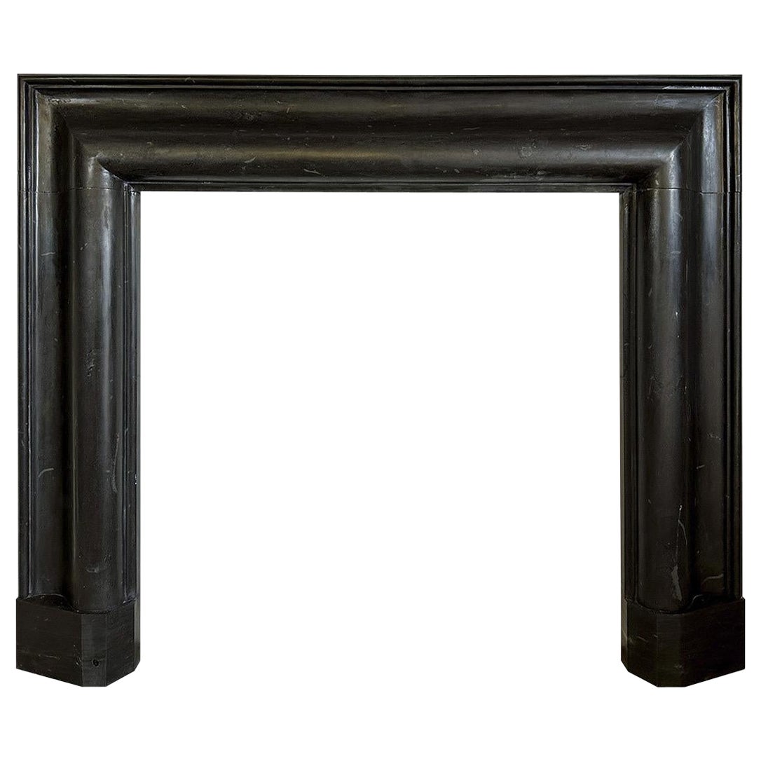 A Large Black Basalt Stone Bolection Fireplace Mantel