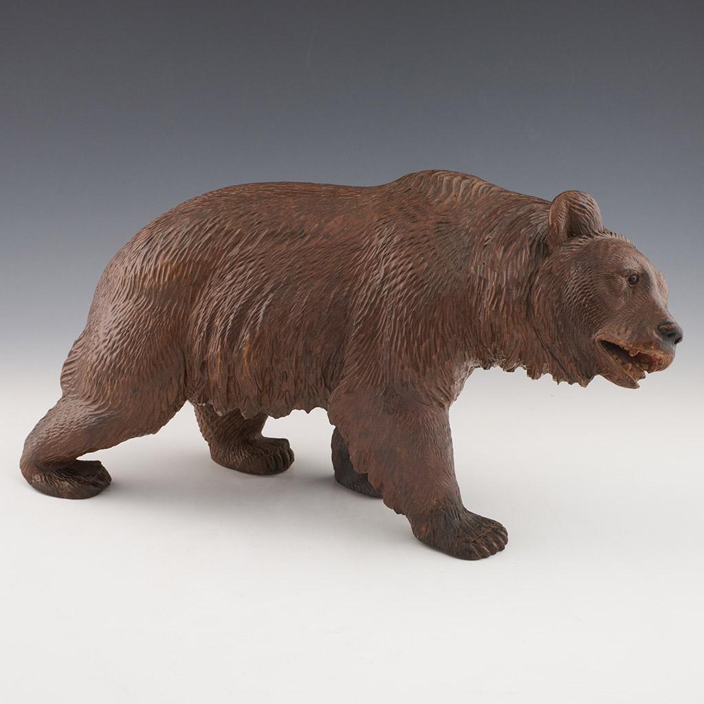 A large Black Forest carved bear. Fine hand carved detail with original glass eyes. Linden wood.

Origin: Swiss

Date: Circa 1890.