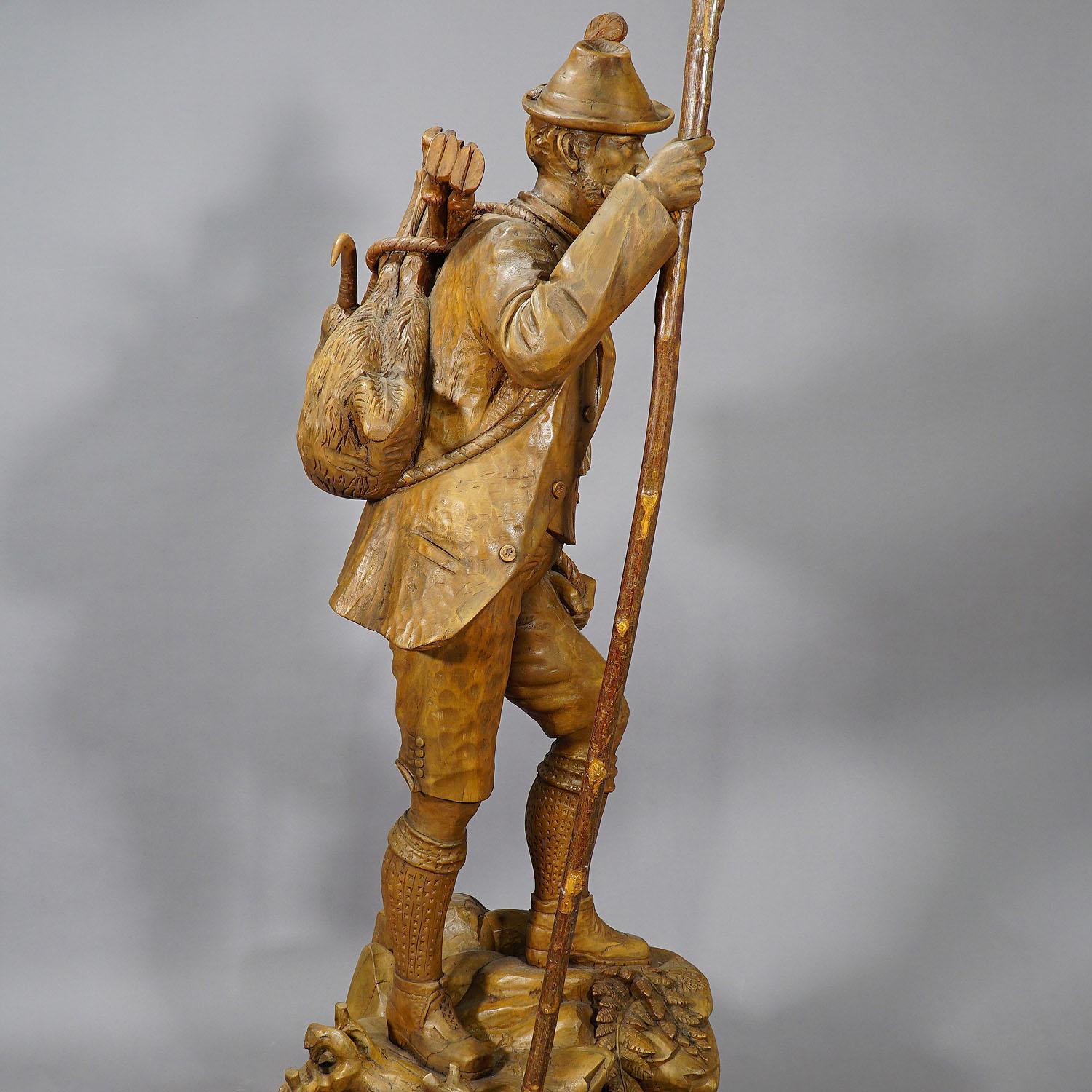 A very large wooden handcarved poacher statue. The poacher is on his way back from the hunt with a hunted chamois on his back. The hand-made sculpture was executed ca. 1900 in the area of Brienz, Swizerland.
Measures: Width 23.62