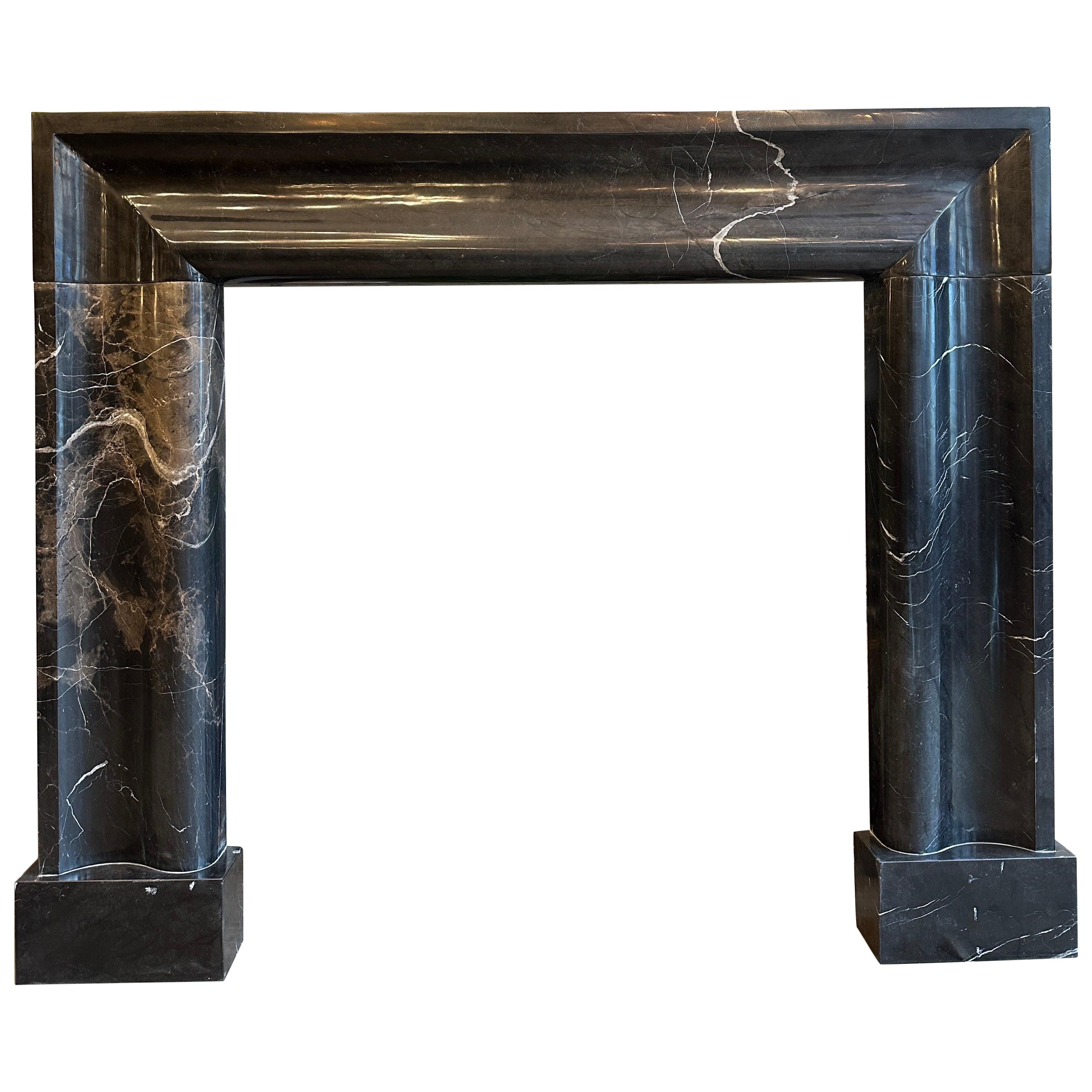 A Large Black Marble Bolection Fireplace Mantle