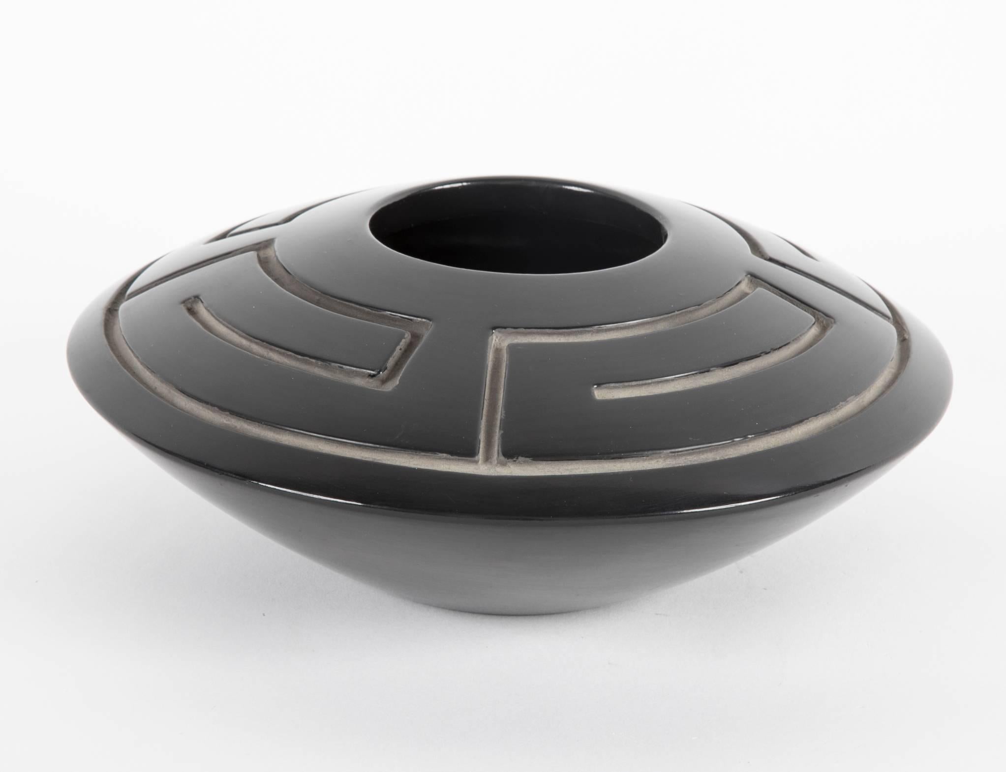 A large saucer form vase with deep incising. Blackware pottery signed and dated on underside. By Jeff Roller, 06, 92.