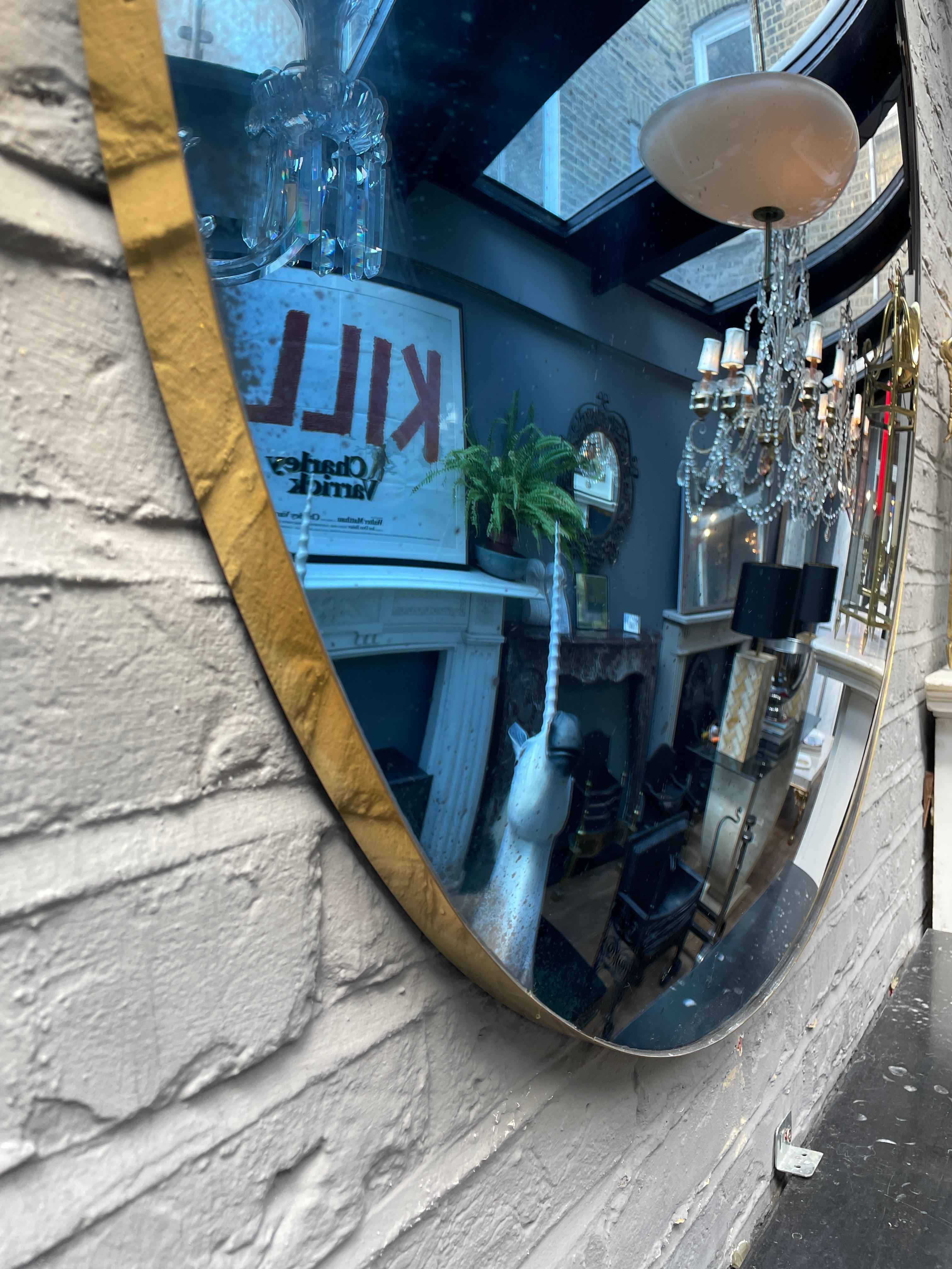 A large deep blue and  distressed convex mirror with simple brass banded framed. Hooks on rear to fix to wall, pair available if desired