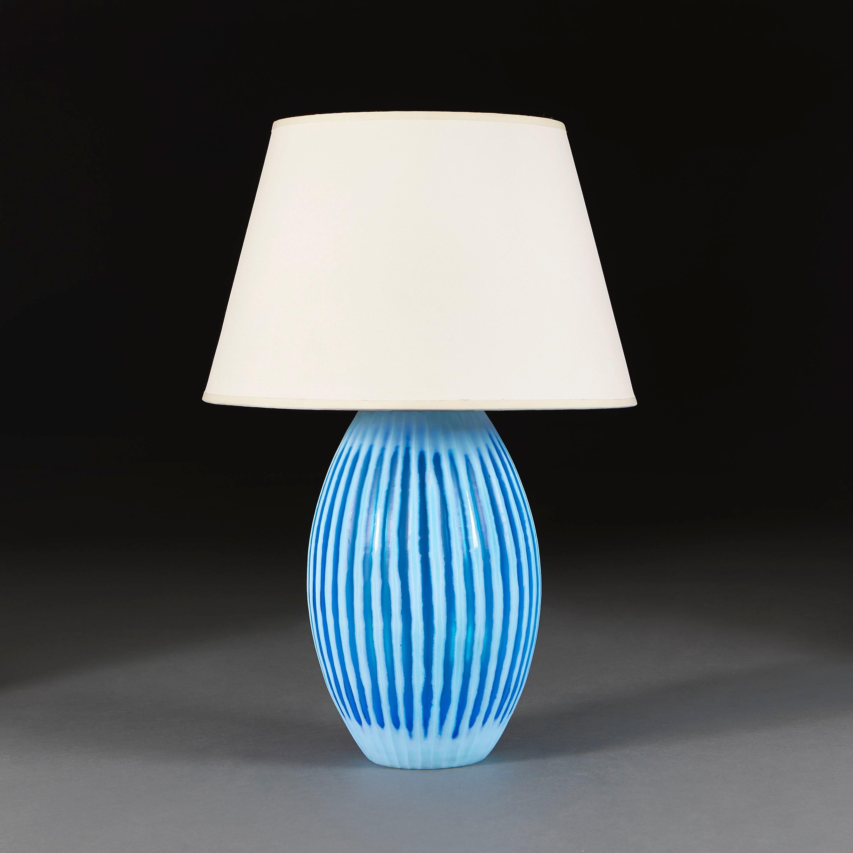 Italy, circa 1960

A midcentury large Murano glass vase in blue glass, of gadrooned oval form, now as a lamp.

Height of vase 38.00cm
Height with shade 67.00cm
Diameter of base 13.00cm
Diameter of body 24.00cm

Please note: This is currently wired