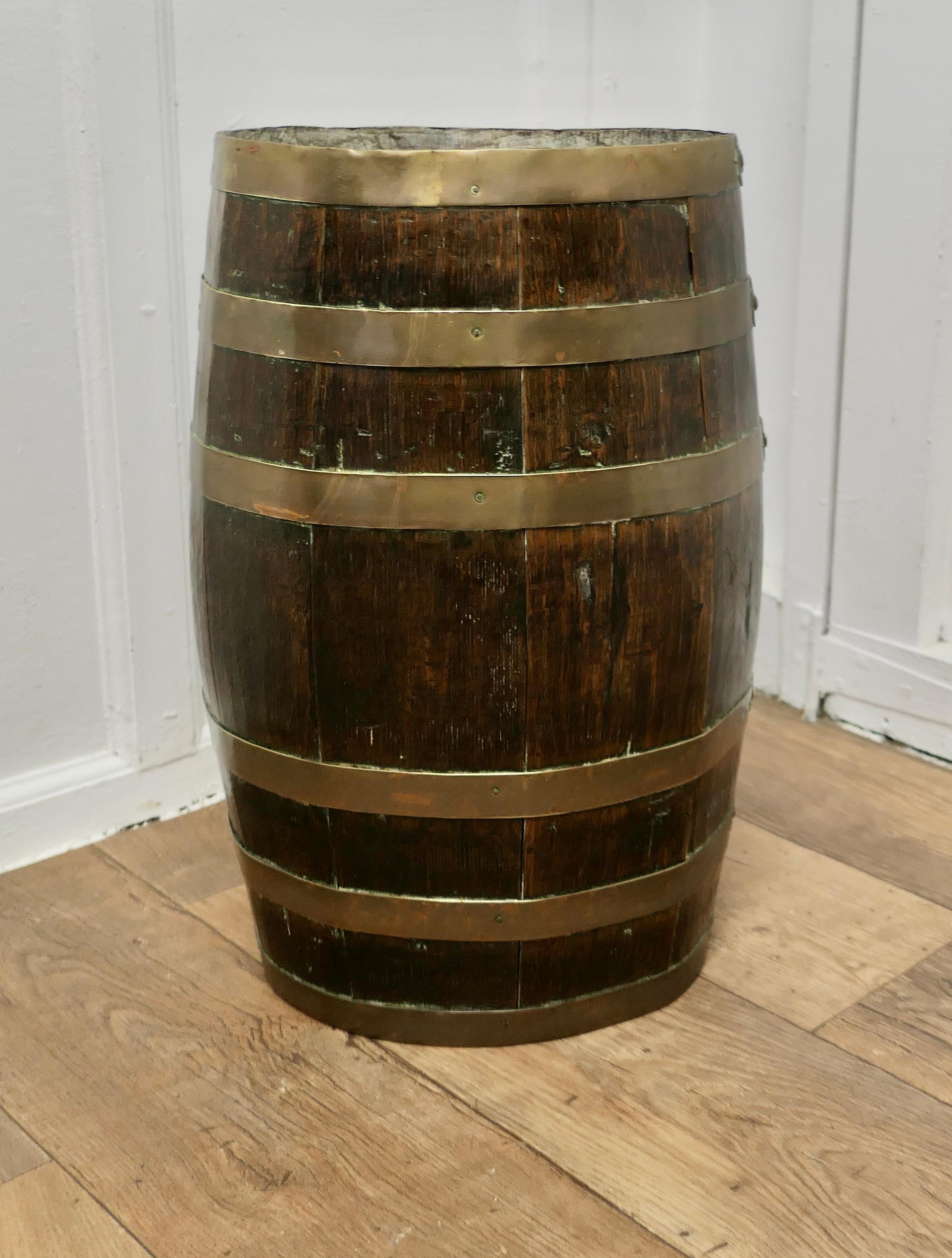 A Large Brass and Oak Barrel Stick Stand

This  good looking piece originated as a 19th Century Rum Barrel, it is made with oak staves and bound with 6 wide brass hoops

The Barrel is in good attractive condition, it is 22” high and 14”  x 11” oval