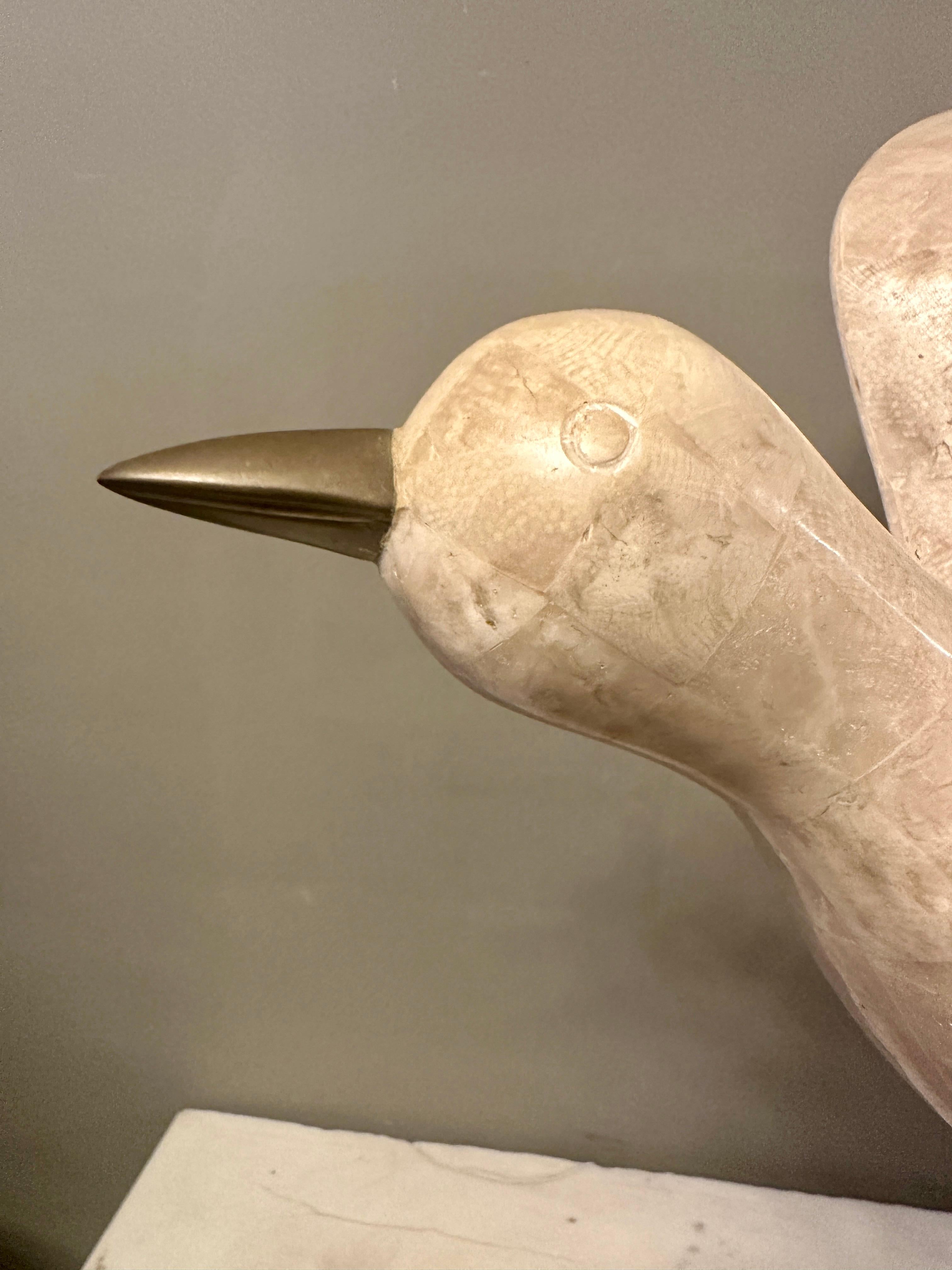 A large seagull sculpture by Maitland Smith USA, In cream tessellated marble with brass legs and beak. Stood on a lacquered parchment base. Great movement and scale. 