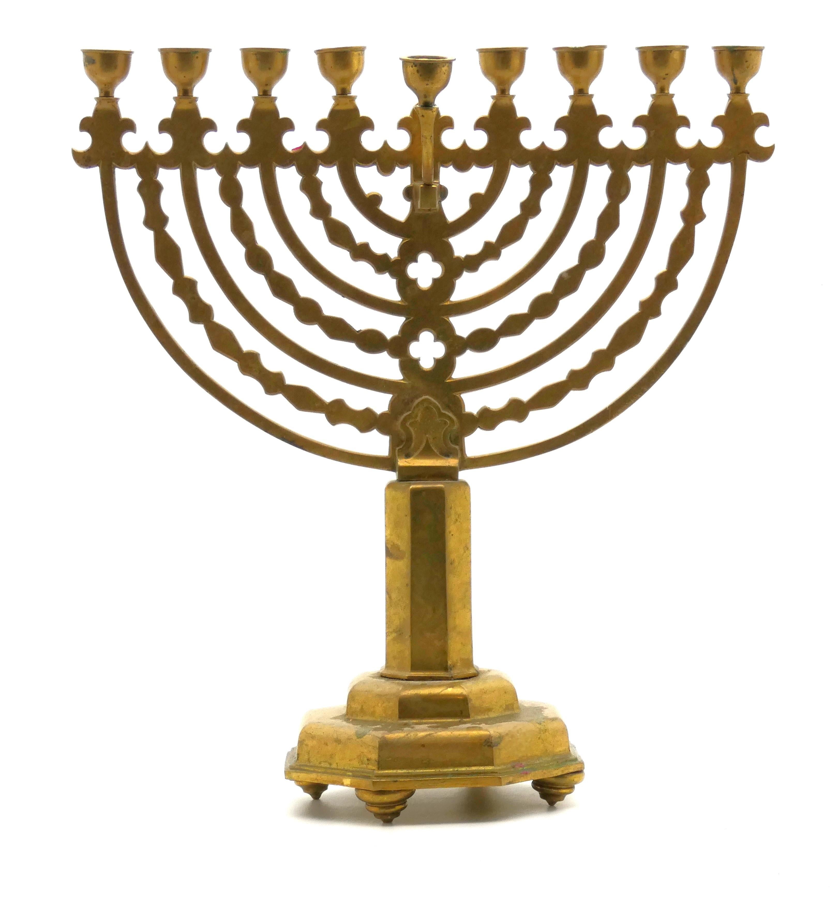 This Large German brass Menorah is indicative of the neo-gothic style of that period and suggests a date around the turn of the twentieth century.

Hanukkah menorah rests on an octagonal stepped base supported by four flywheel-shaped legs. 

Base is