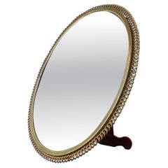 A Large Brass Ring Easel Mirror