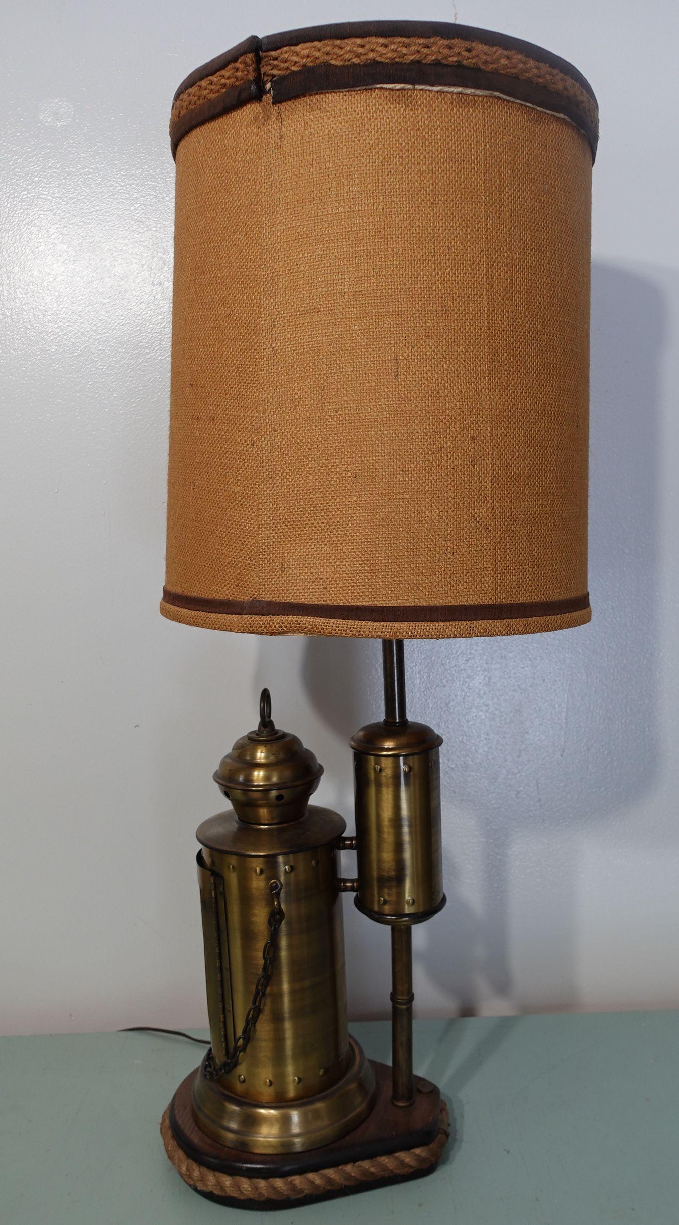A large brasstable lamp with shade. It has 3 way liting, the bulb lited, the small red light candle-like lited, and both lited, very unique.



