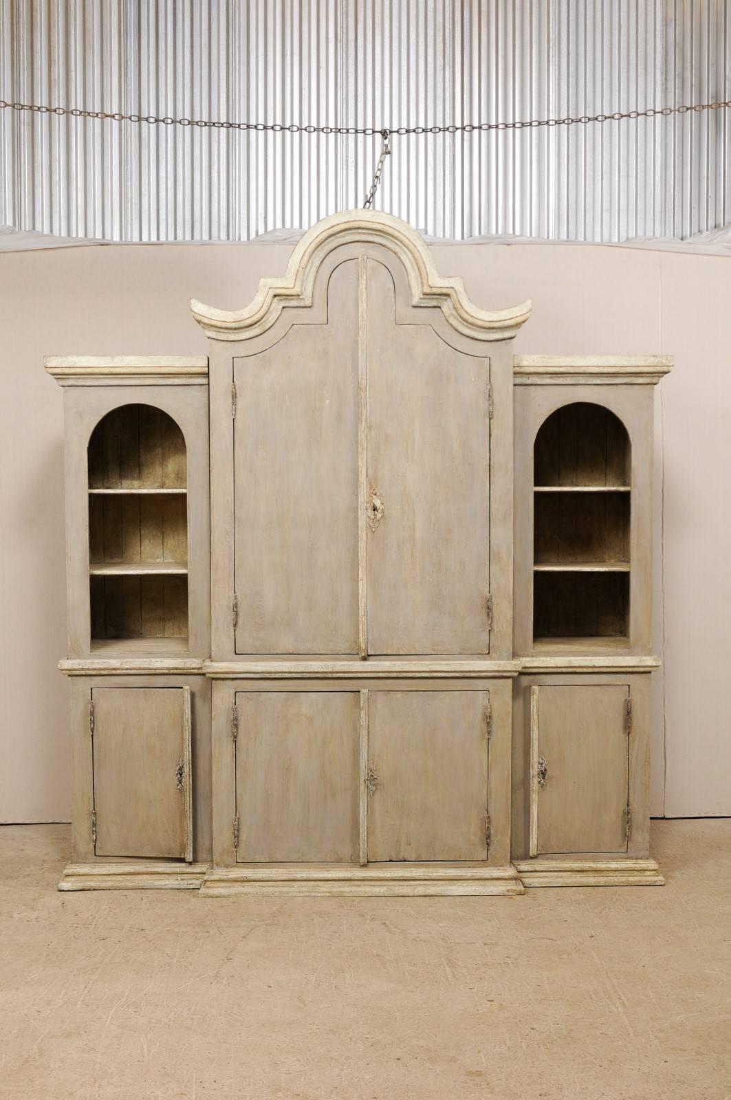 A large size vintage Brazilian painted wood cabinet. This custom Brazilian cabinet stands over 8.5 feet tall and roughly 8 feet wide, allowing for an abundance of storage and display needs. The cabinet features a larger mid-section which both steps
