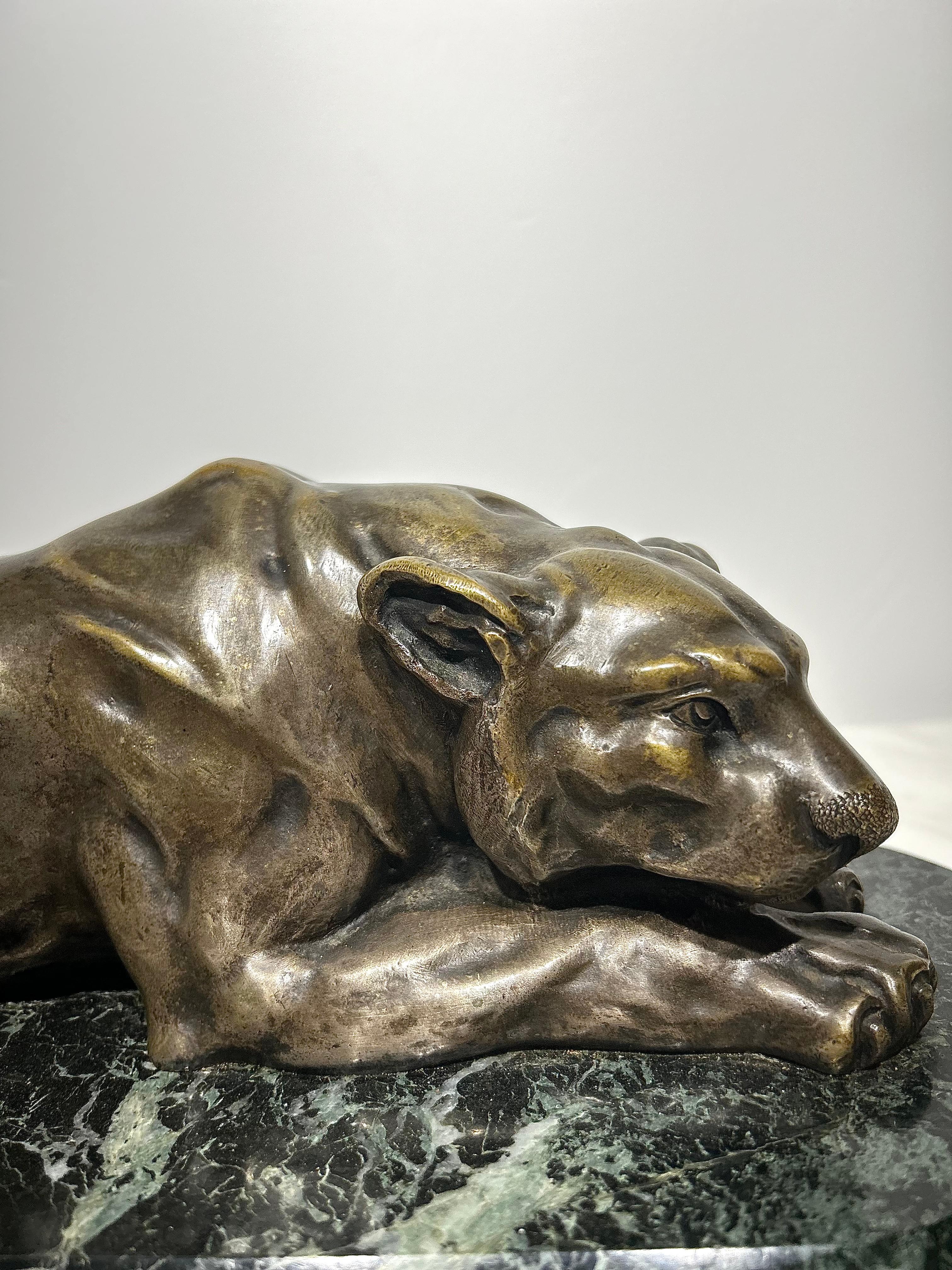A lioness sculpted in bronze mounted onto a verde antico marble base. Designed and signed by the sculptor in the mid 19th century, this detailed piece has a wonderful patina finish and would look fantastic in anyone’s home.