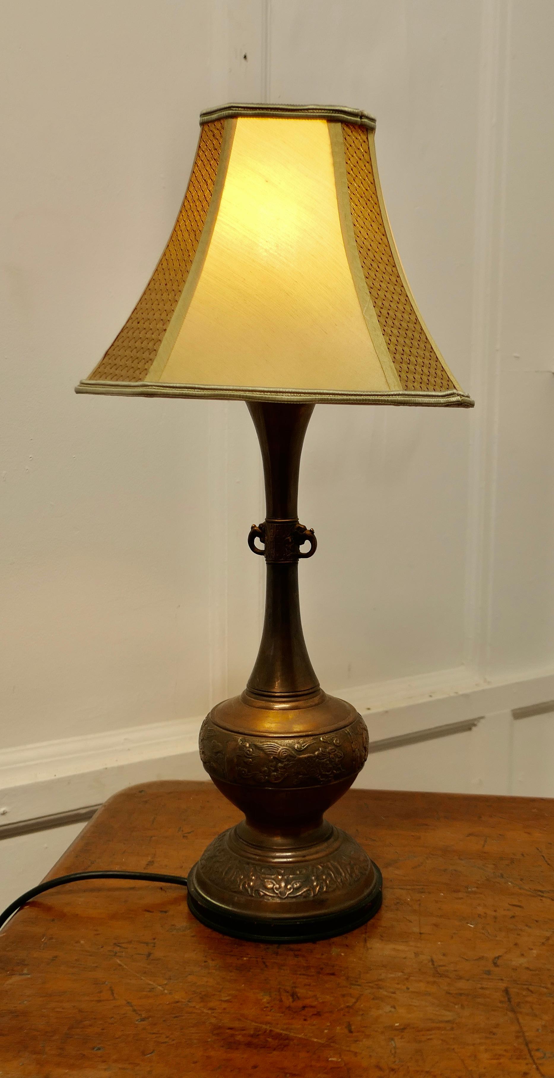 A Large Bulbous Embossed Copper Table Lamp 

This is a very large lamp, it has an Islamic look with an embossed pattern around 
The lamp is fully wired and in good condition, a statement piece in any room, I have shown it with its original lampshade