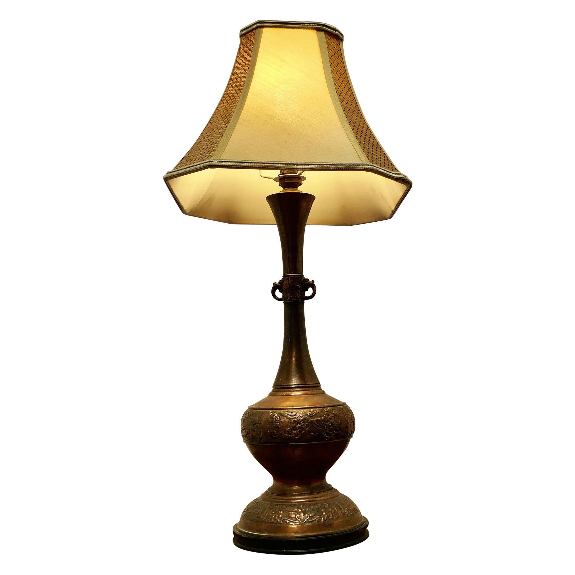 A Large Bulbous Embossed Copper Table Lamp