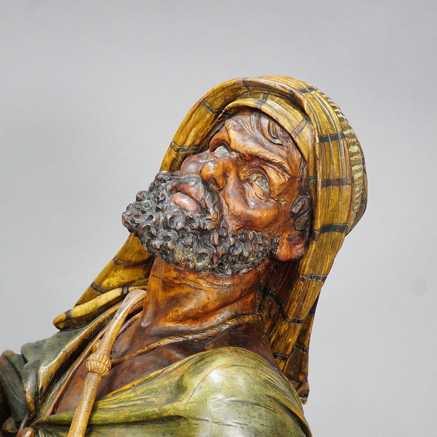 A masterly carved wooden statue of an Arab drinking coffee and smoking his pipe. An antique shop window decoration from a coffee shop or a tobacco shop - hand carved in Vienna, Austria, circa 1900.

Measures: Length 22.83