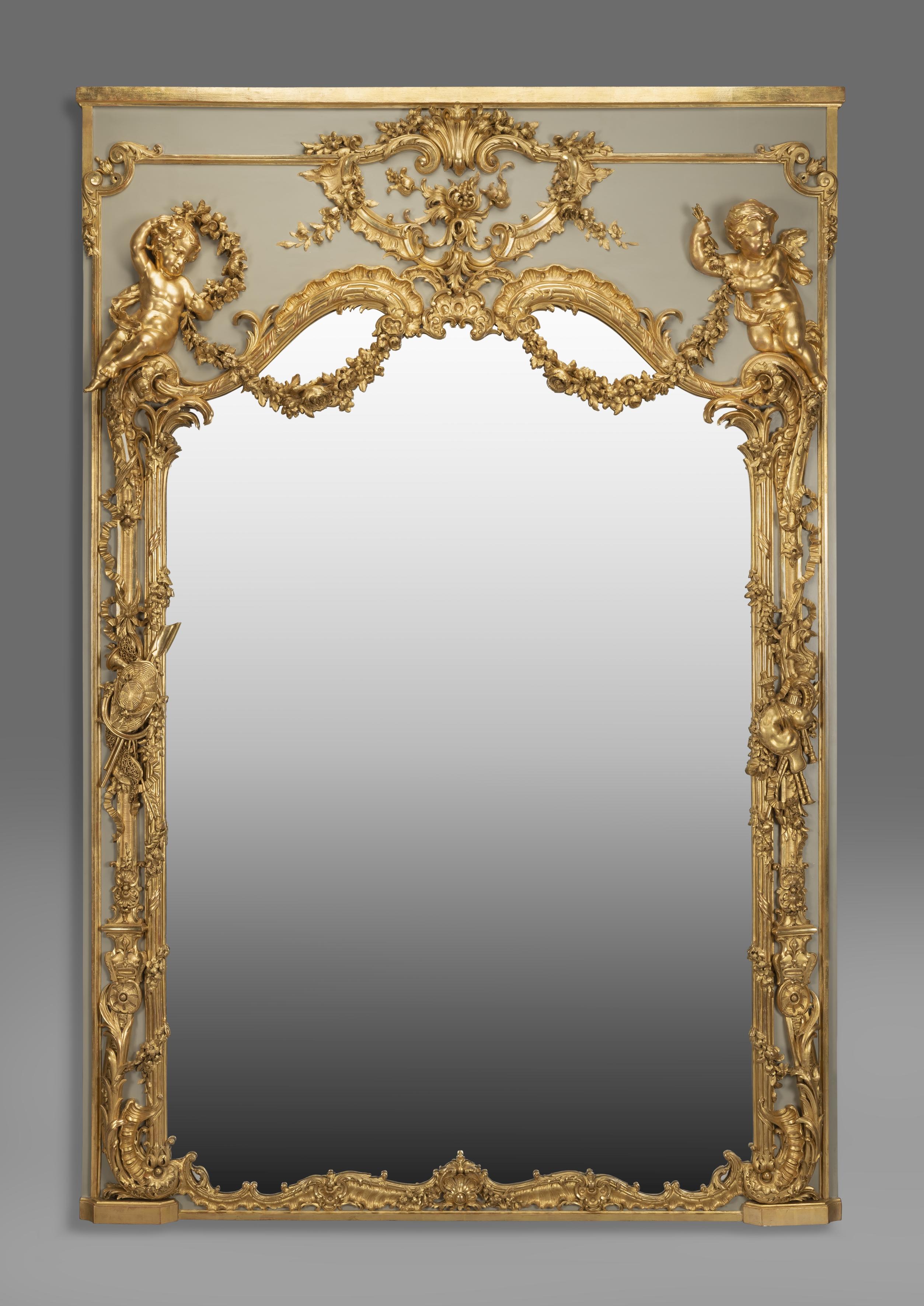 A large and very finely carved Louis XV style parcel-gilt and painted trumeau mirror.

French, circa 1890. 

This exceptional and very rare trumeau mirror has an arched mirror plate framed by Rococo style foliate and acanthus carving with,